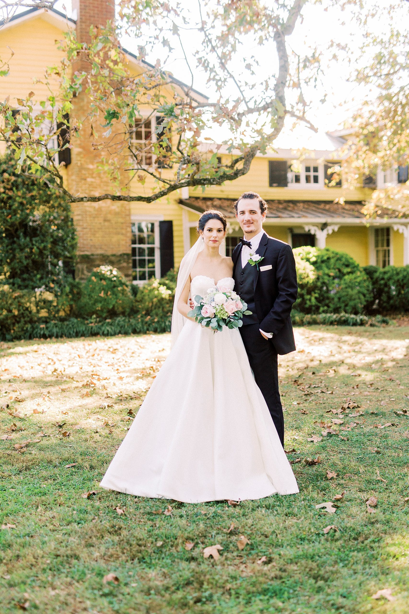 1812 Hitching Post wedding portraits of bride and groom standing together