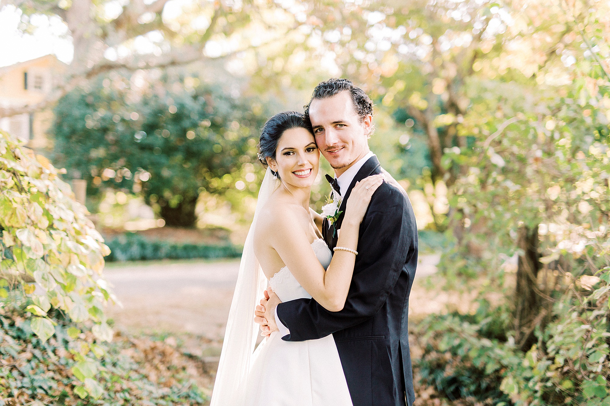 newlyweds hug on the lawn at 1812 Hitching Post