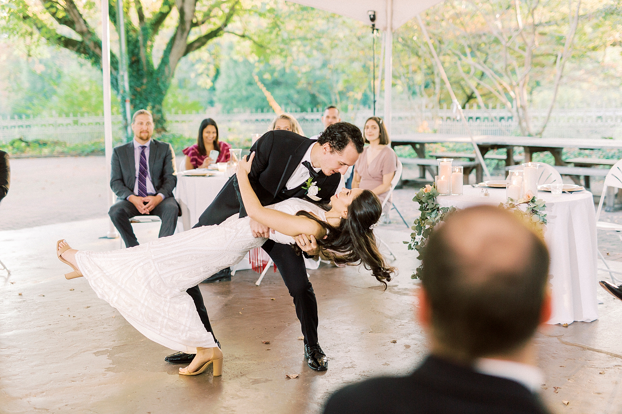 groom dips bride during first dance at NC wedding reception