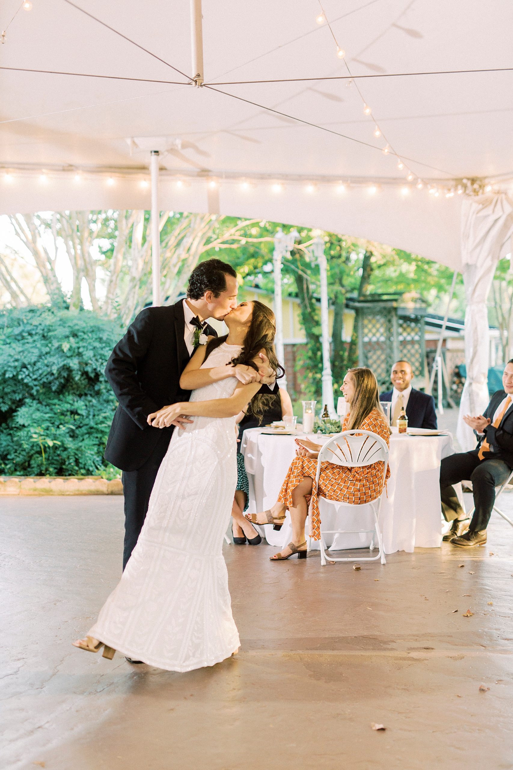 newlyweds kiss during first dance at NC wedding reception