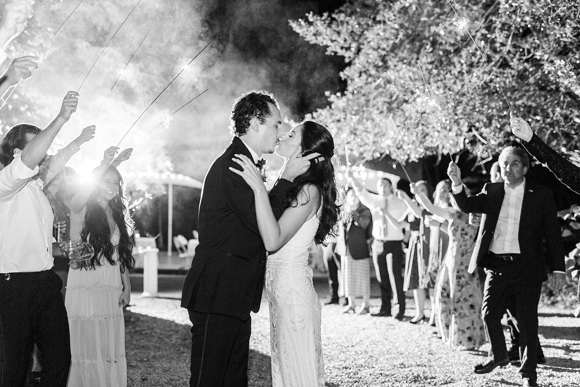 bride and groom kiss during sparkler exit