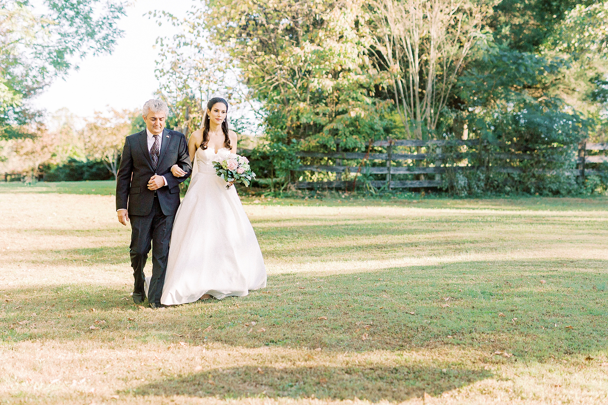 bride walks to ceremony with dad
