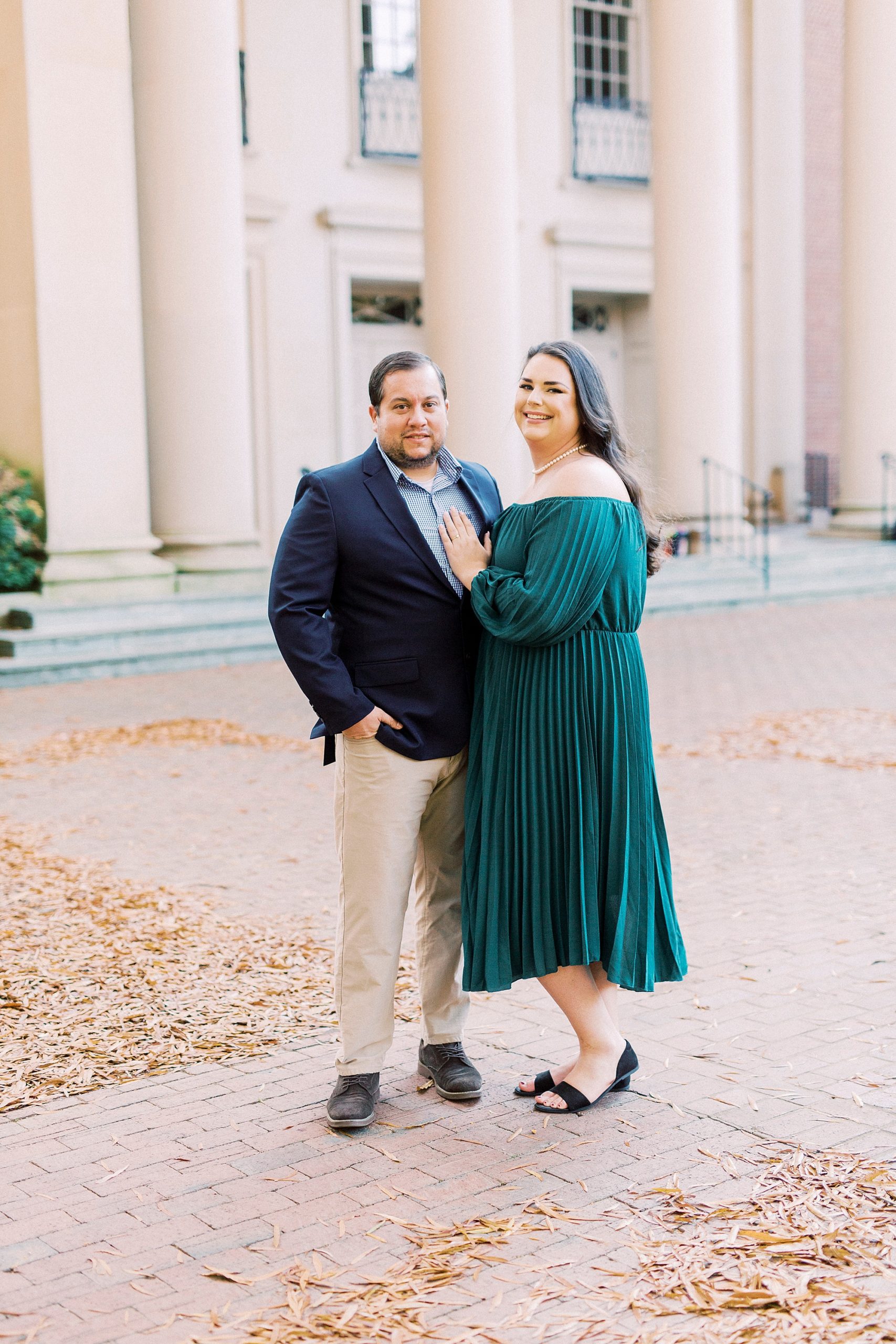 bride and groom pose outside historic building in Downtown Davidson