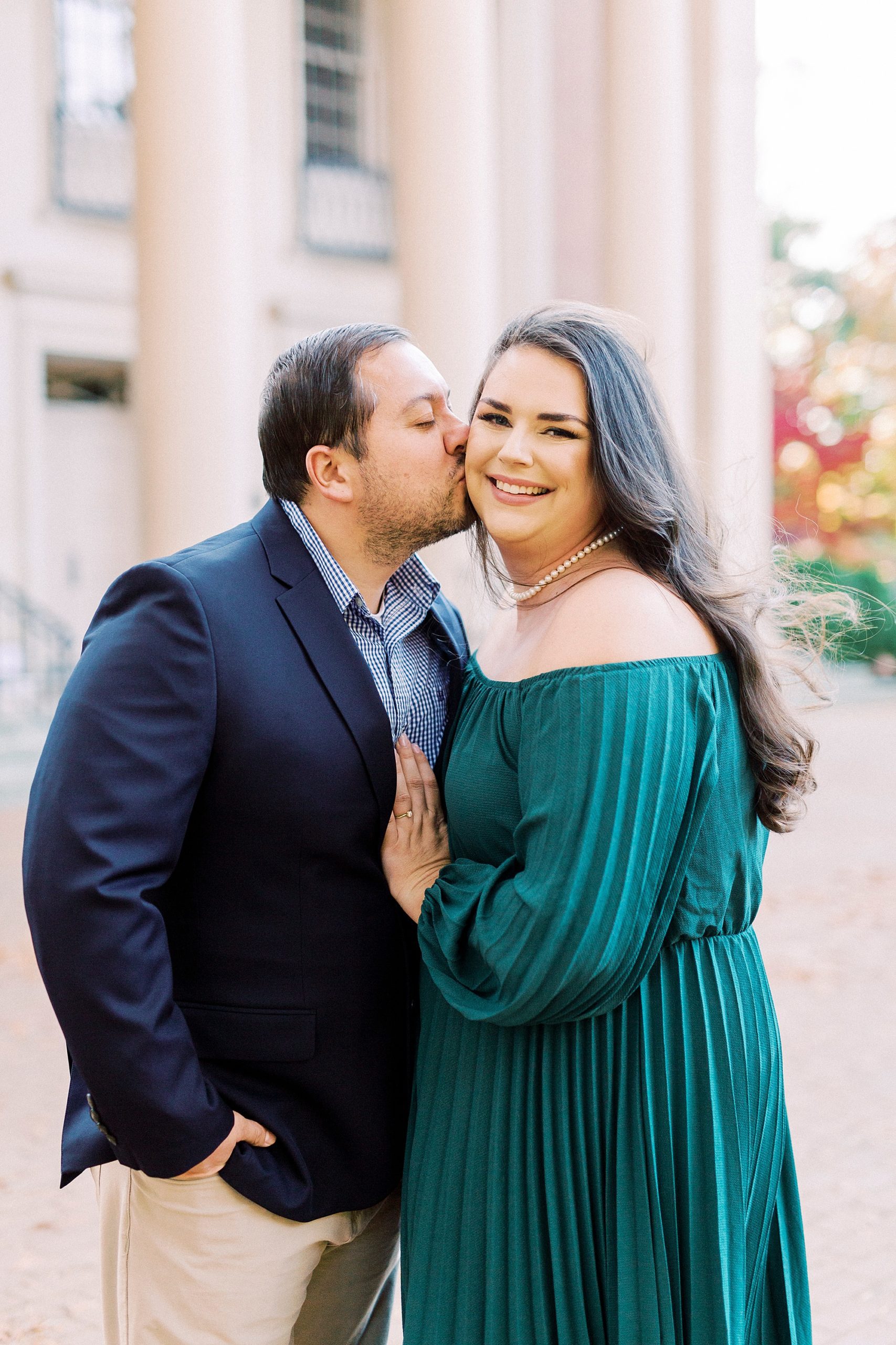 groom kisses bride's cheek during NC engagement photos