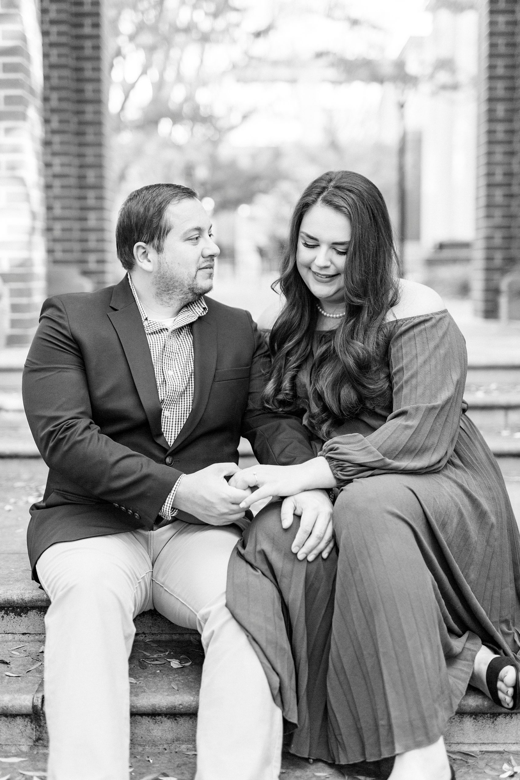 bride and groom hold hands on steps of walkthrough in Downtown Davidson
