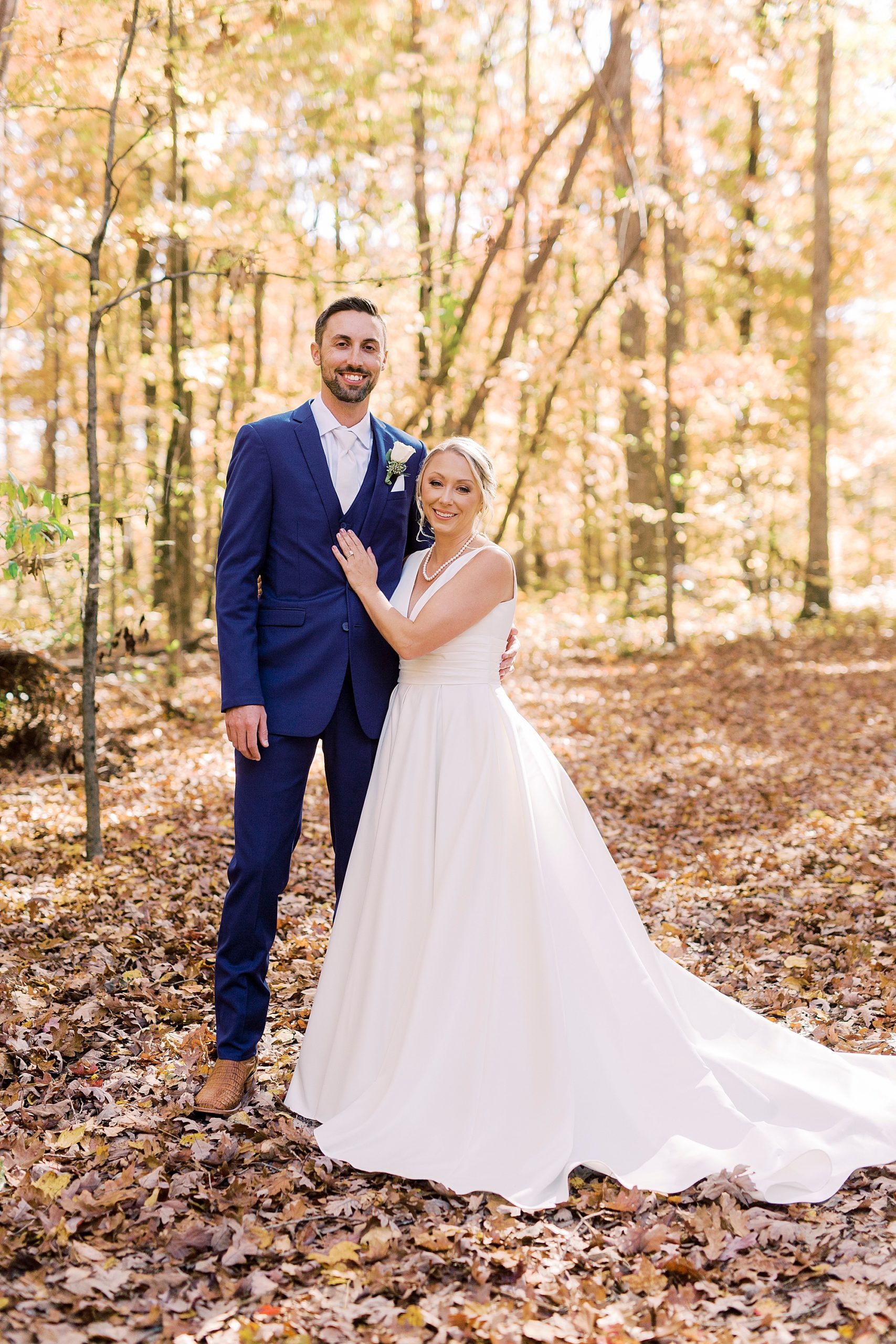 bride and groom hug in woods before fall Farm at Brusharbor wedding
