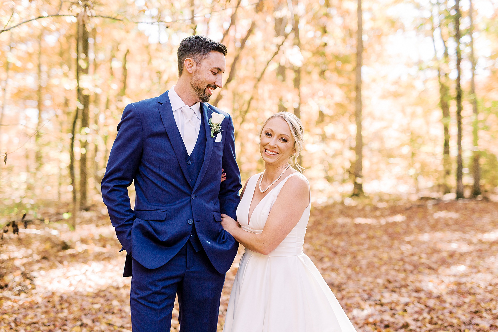 couple hugs during fall wedding portraits in NC