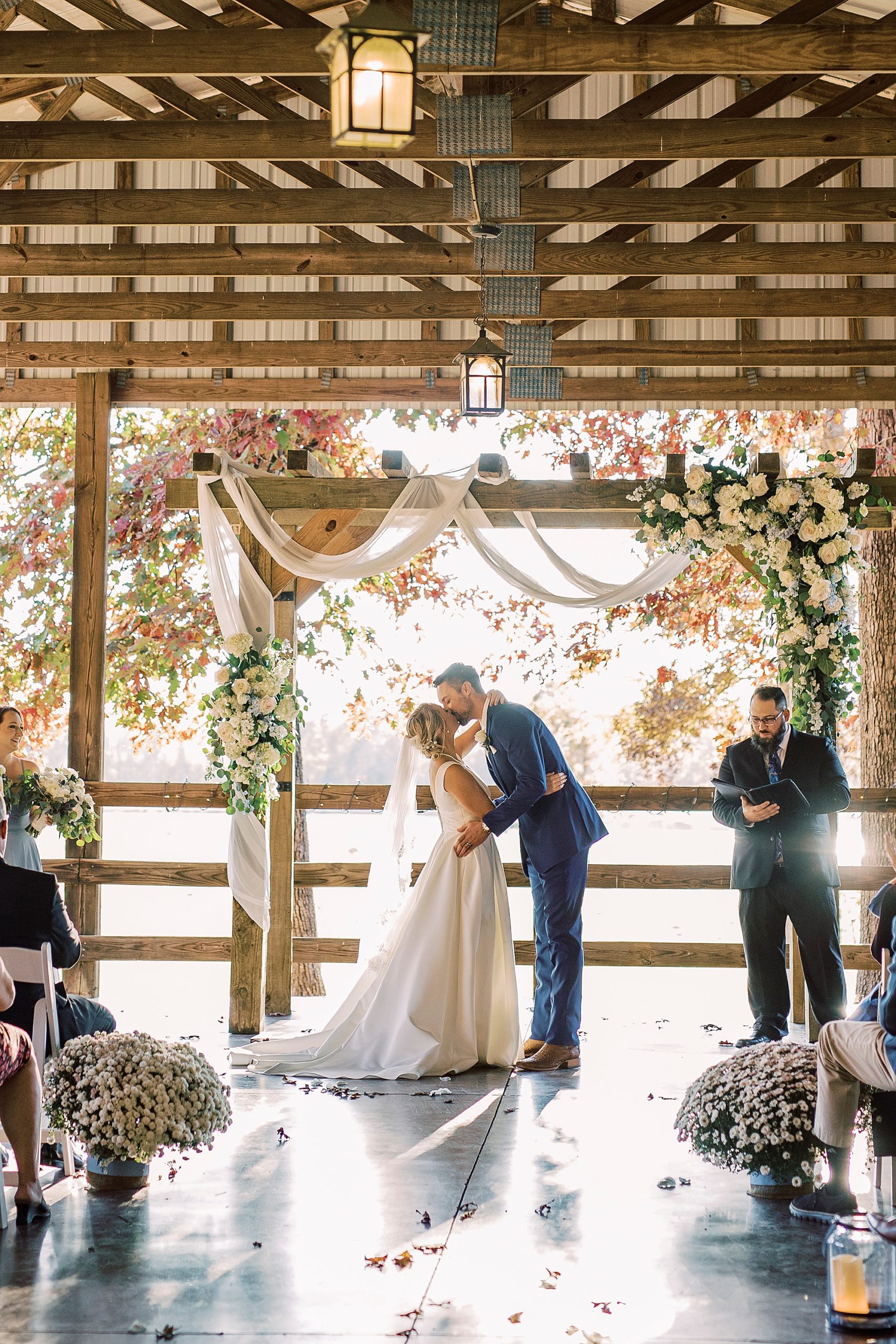 newlyweds kiss after outdoor fall ceremony