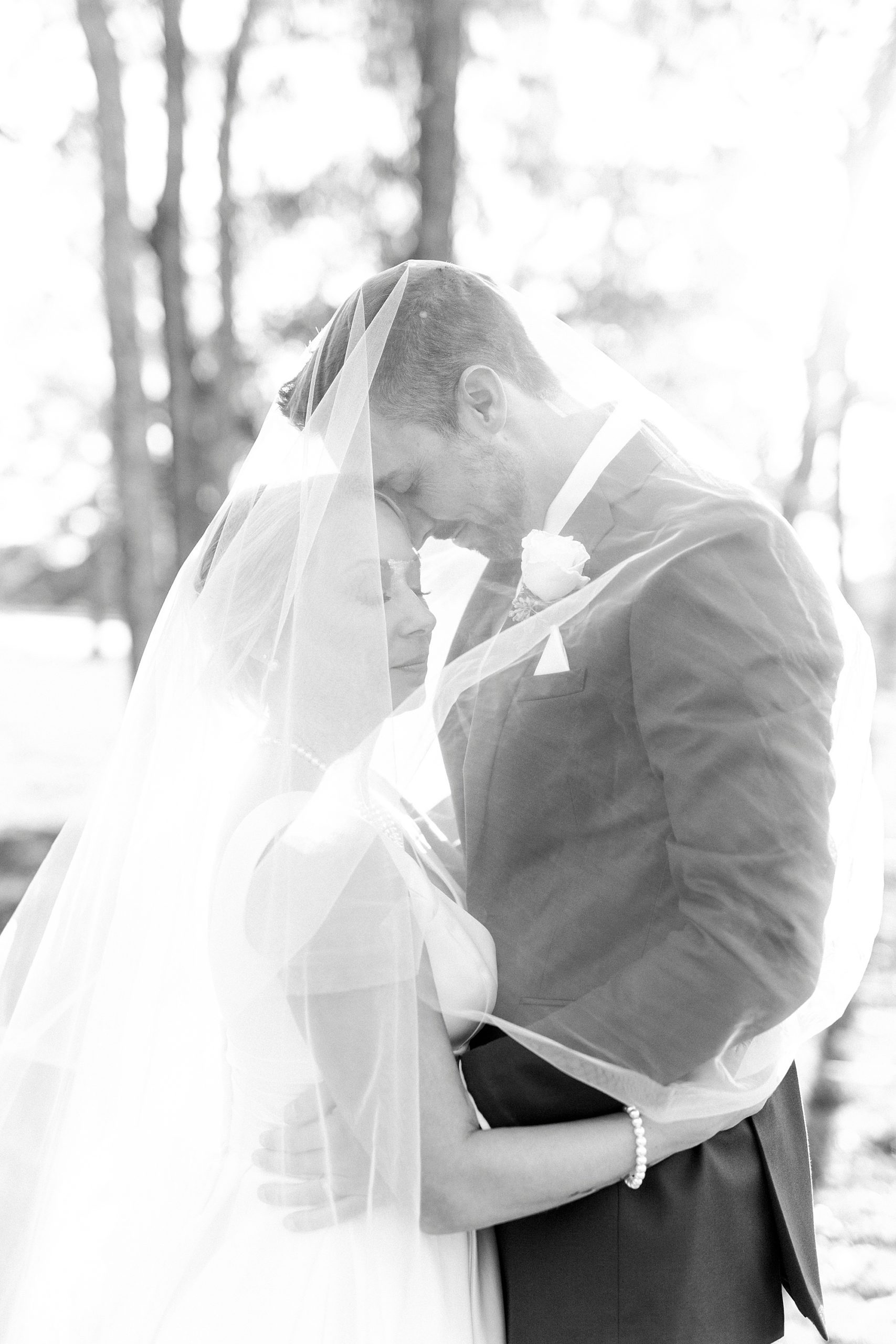 couple stands with foreheads touching during photos at the Farm at Brusharbor