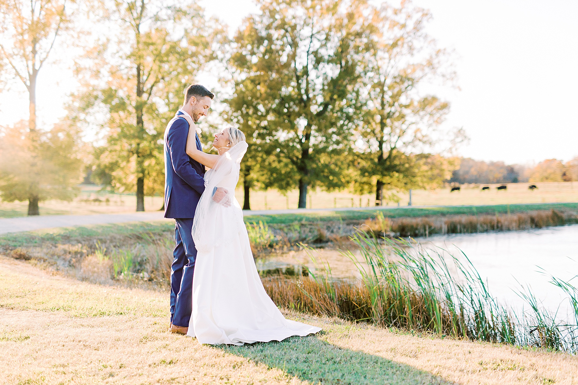 bride and from pose alongside lake at the Farm at Brusharbor