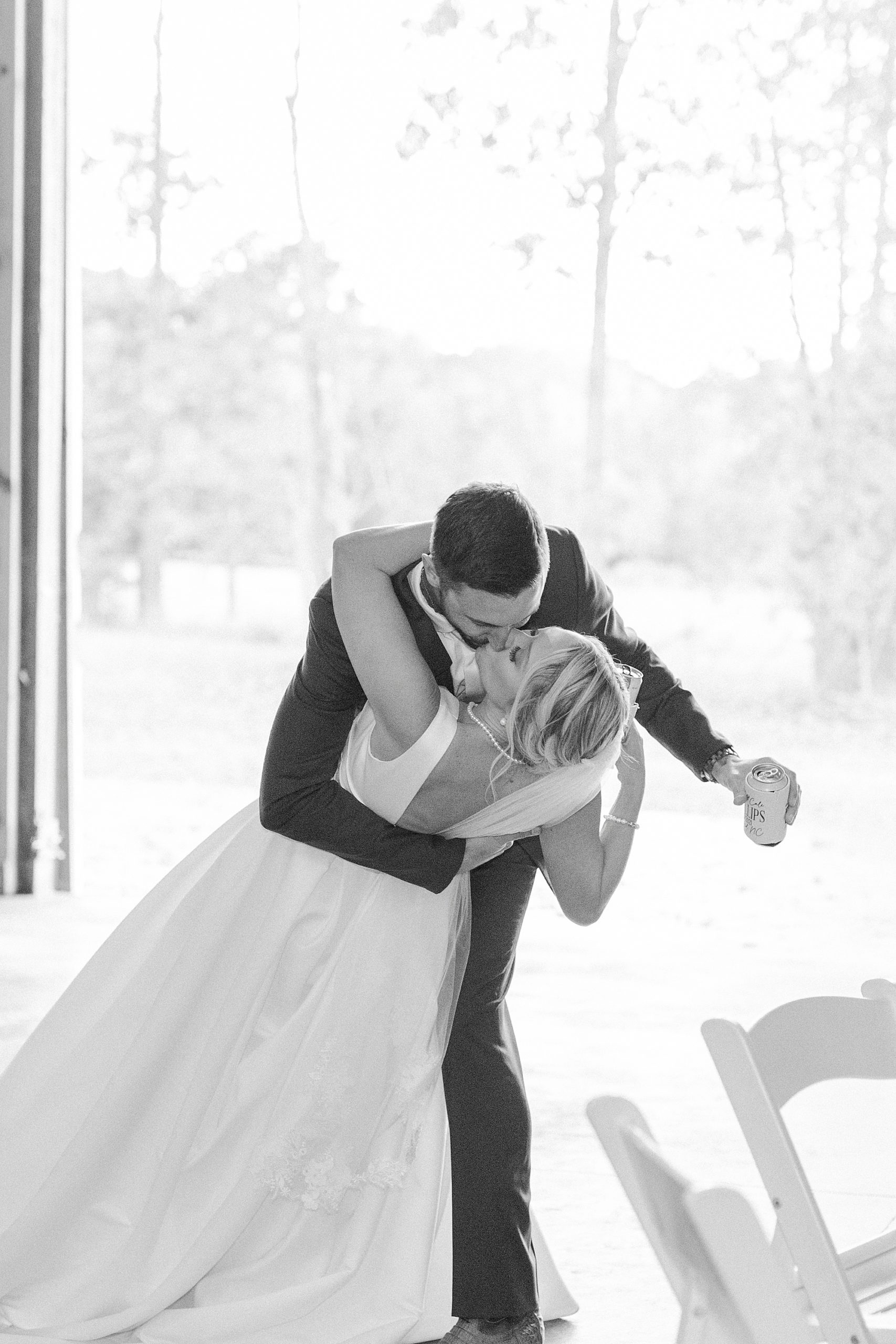 groom dips bride kissing her during reception