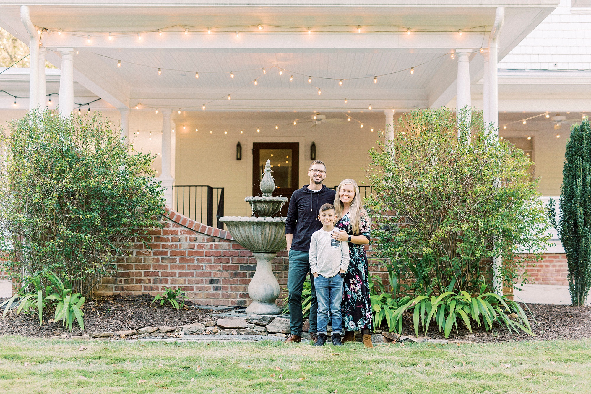 family poses outside Ritchie Hill