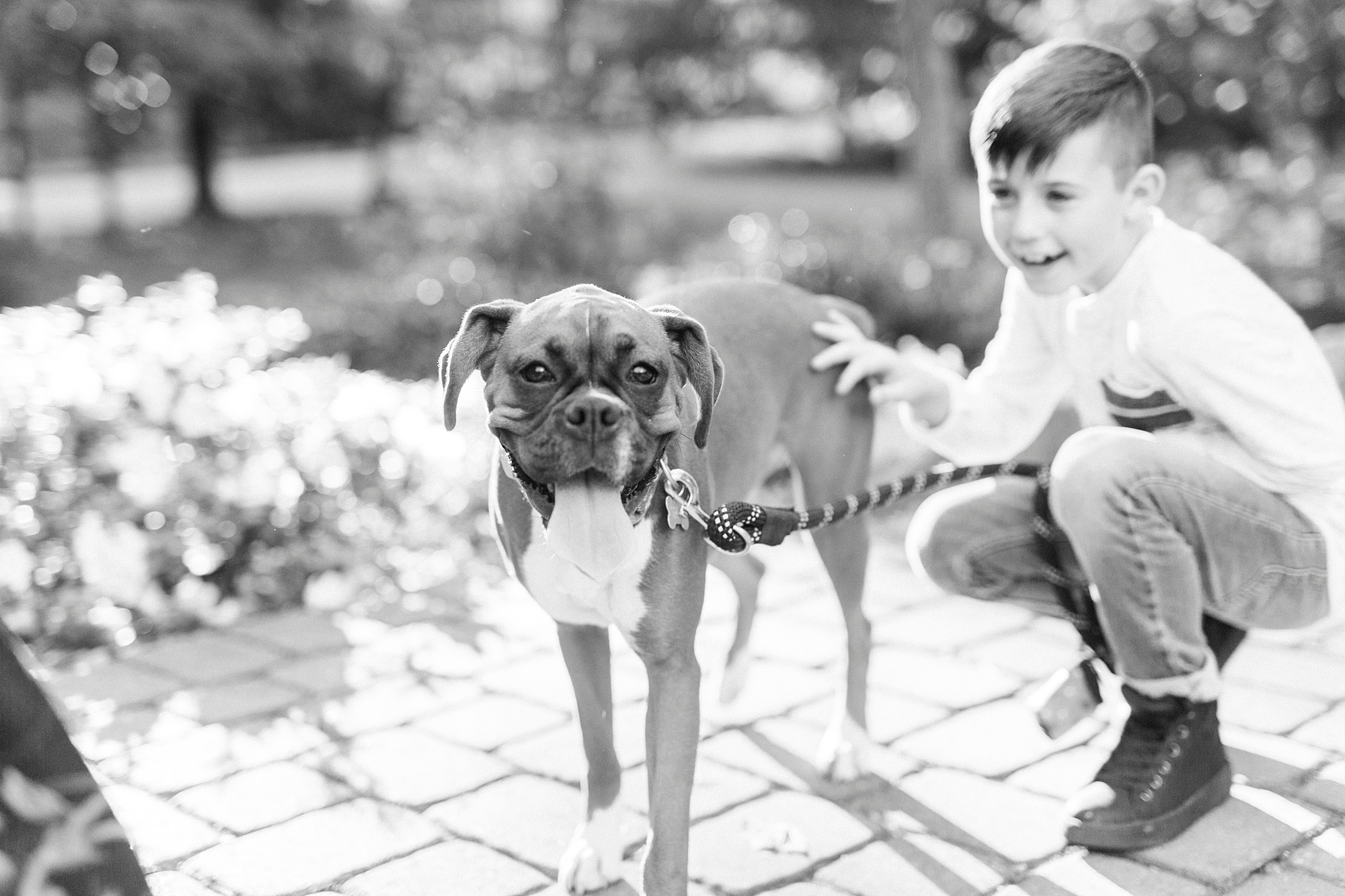 boy and dog sit on patio at Ritchie Hill