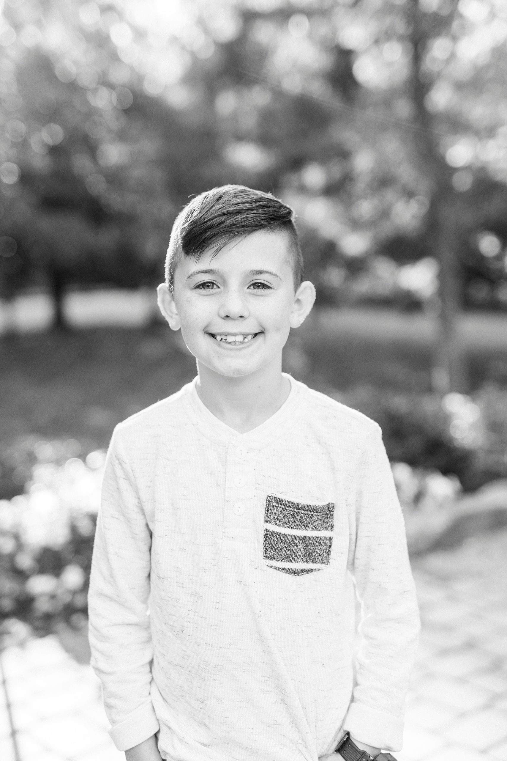 young boy poses with hands in pockets during family photos at Ritchie Hill
