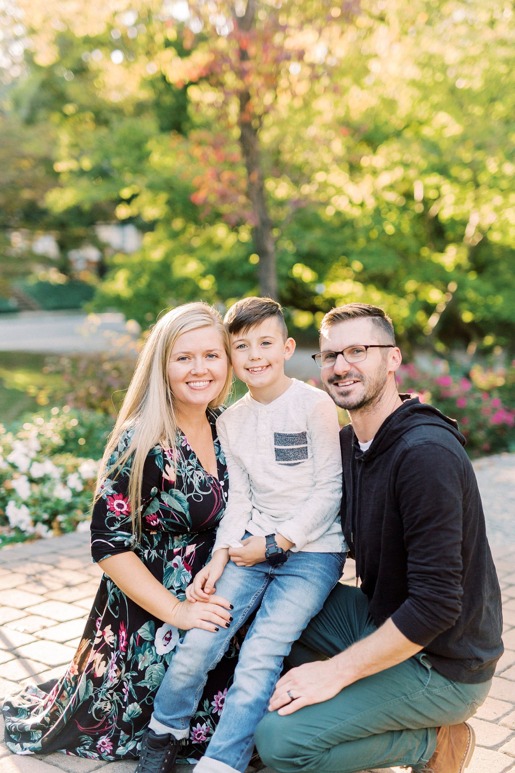 family of three poses on patio at Ritchie Hill