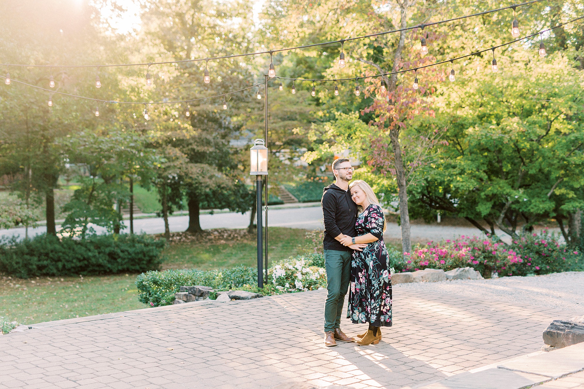 woman leans against husbands chest during family photos