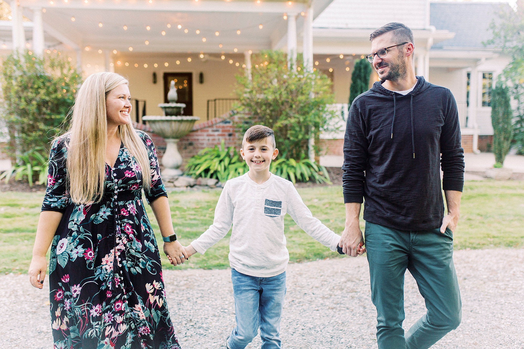 family of three walks outside Ritchie Hill