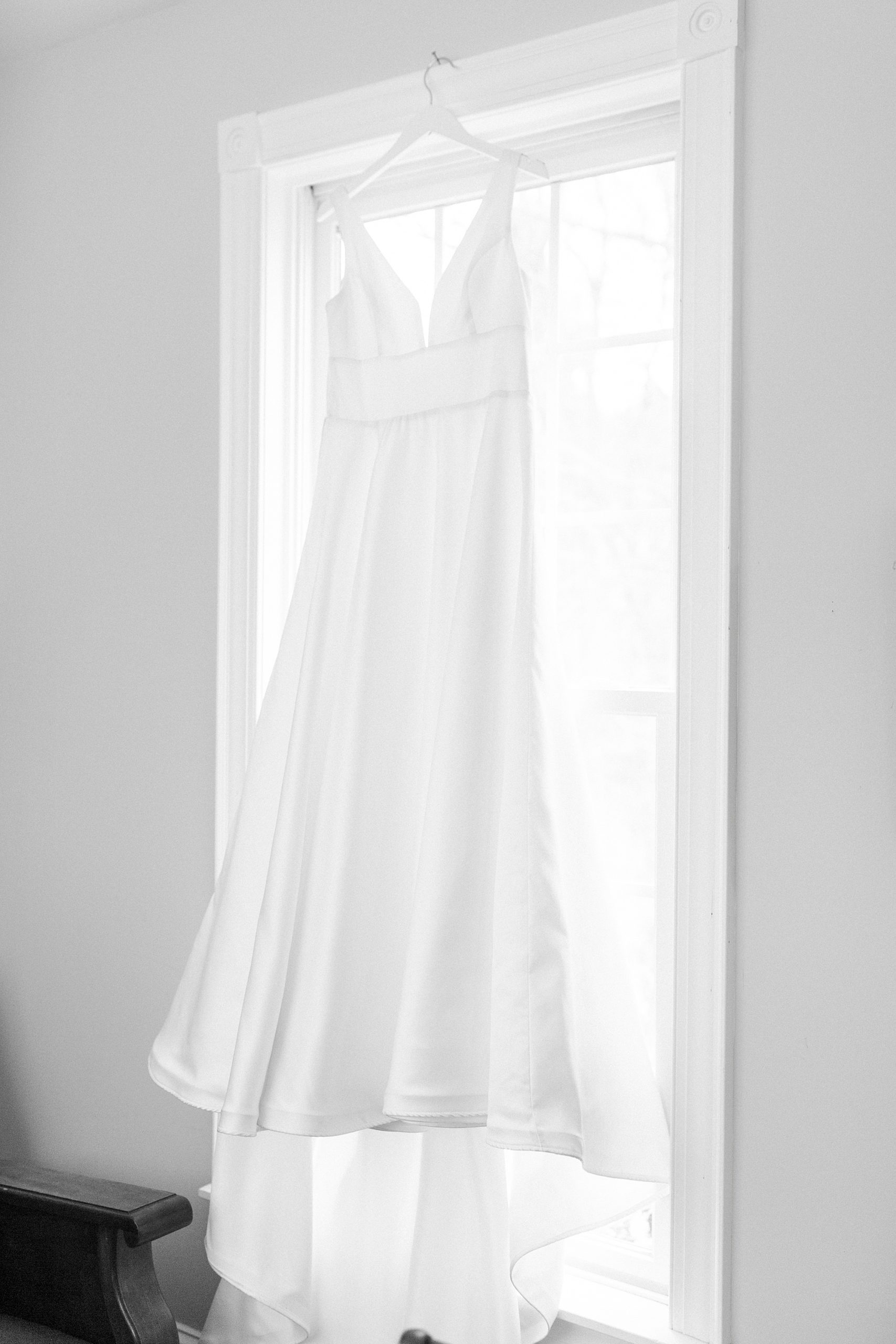 bride's wedding dress hangs on family farm
