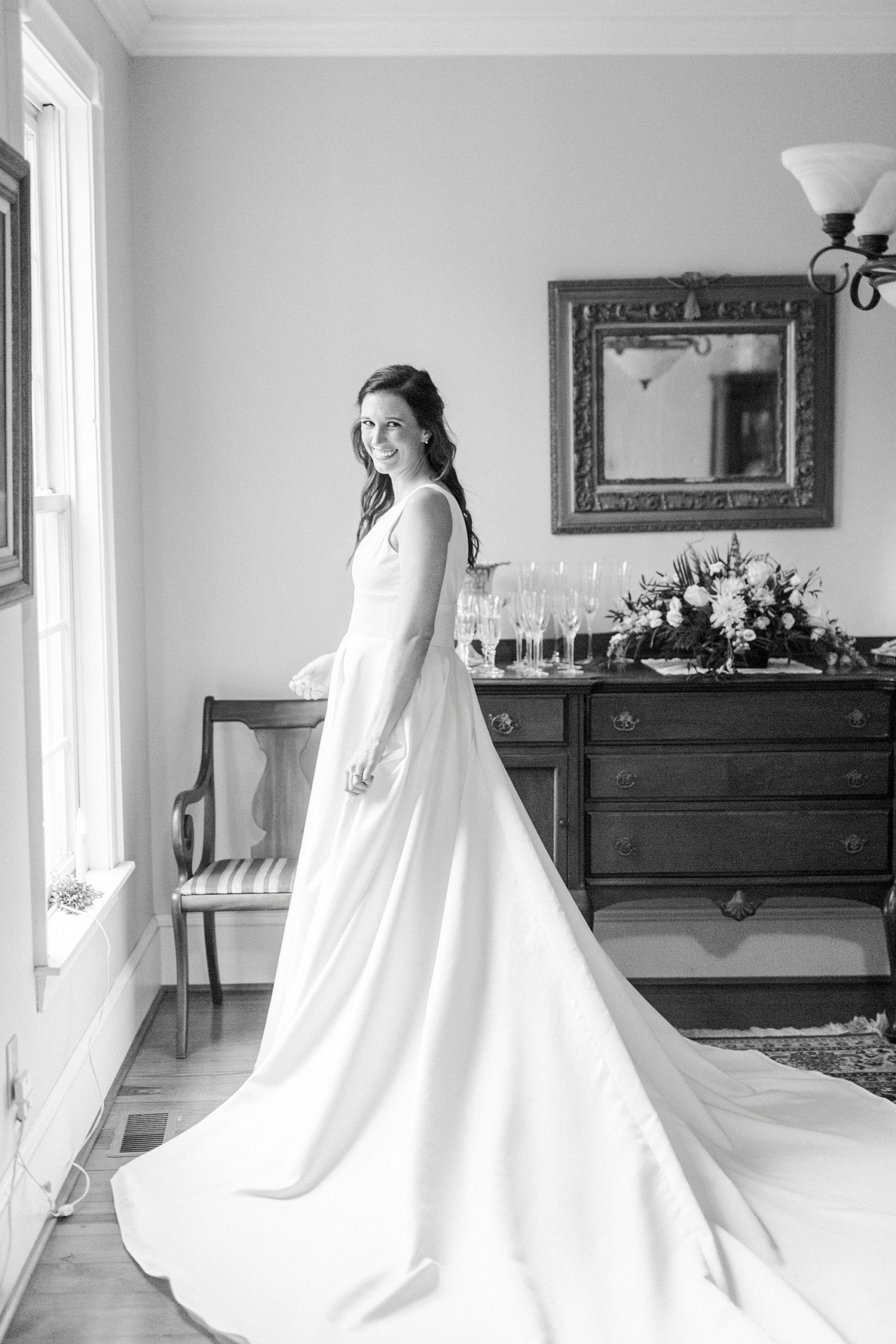 bride stands with wedding dress train around her