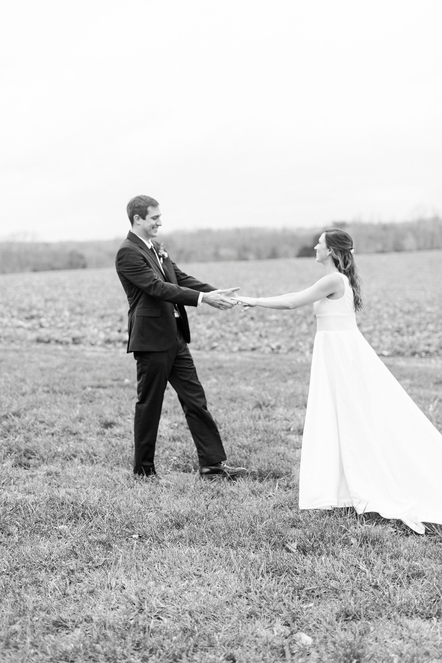 groom looks at bride during first look