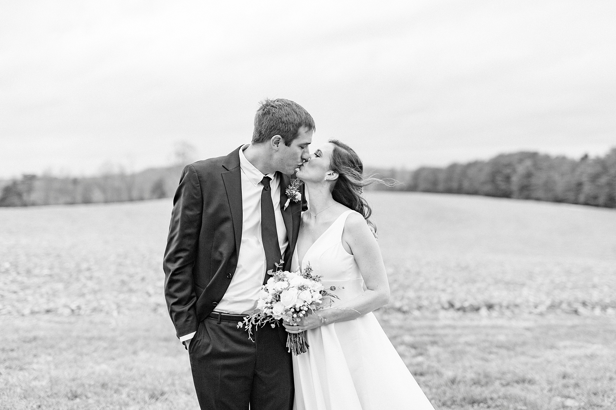 couple kisses during portraits for romantic winter wedding in Bedford VA