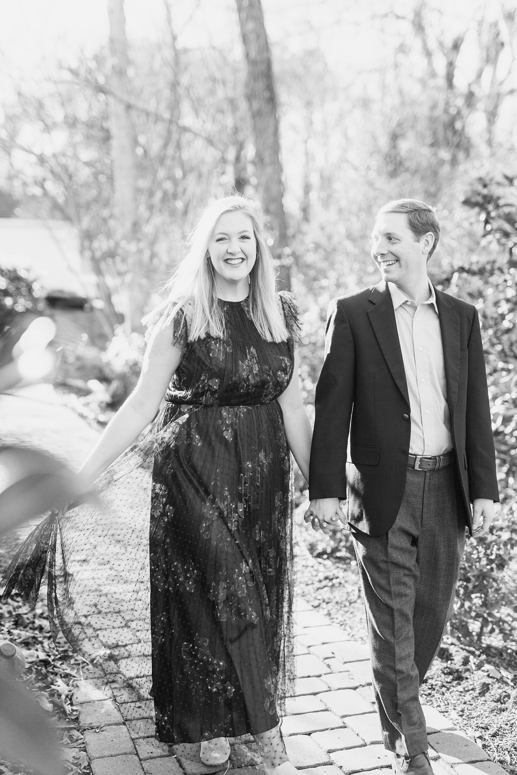bride and groom hold hands walking through Ritchie Hill