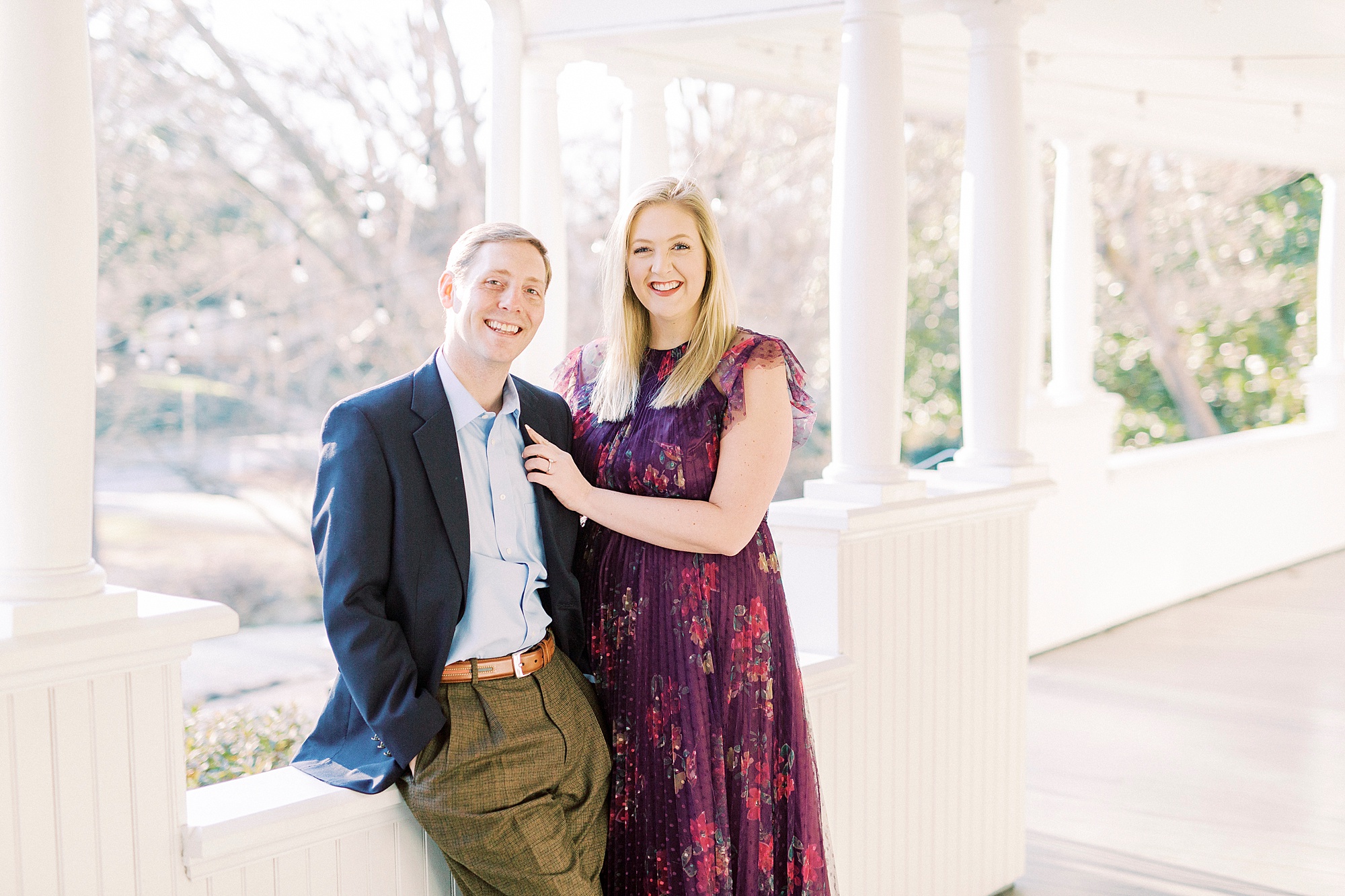 bride and groom sit together on white patio at Ritchie Hill