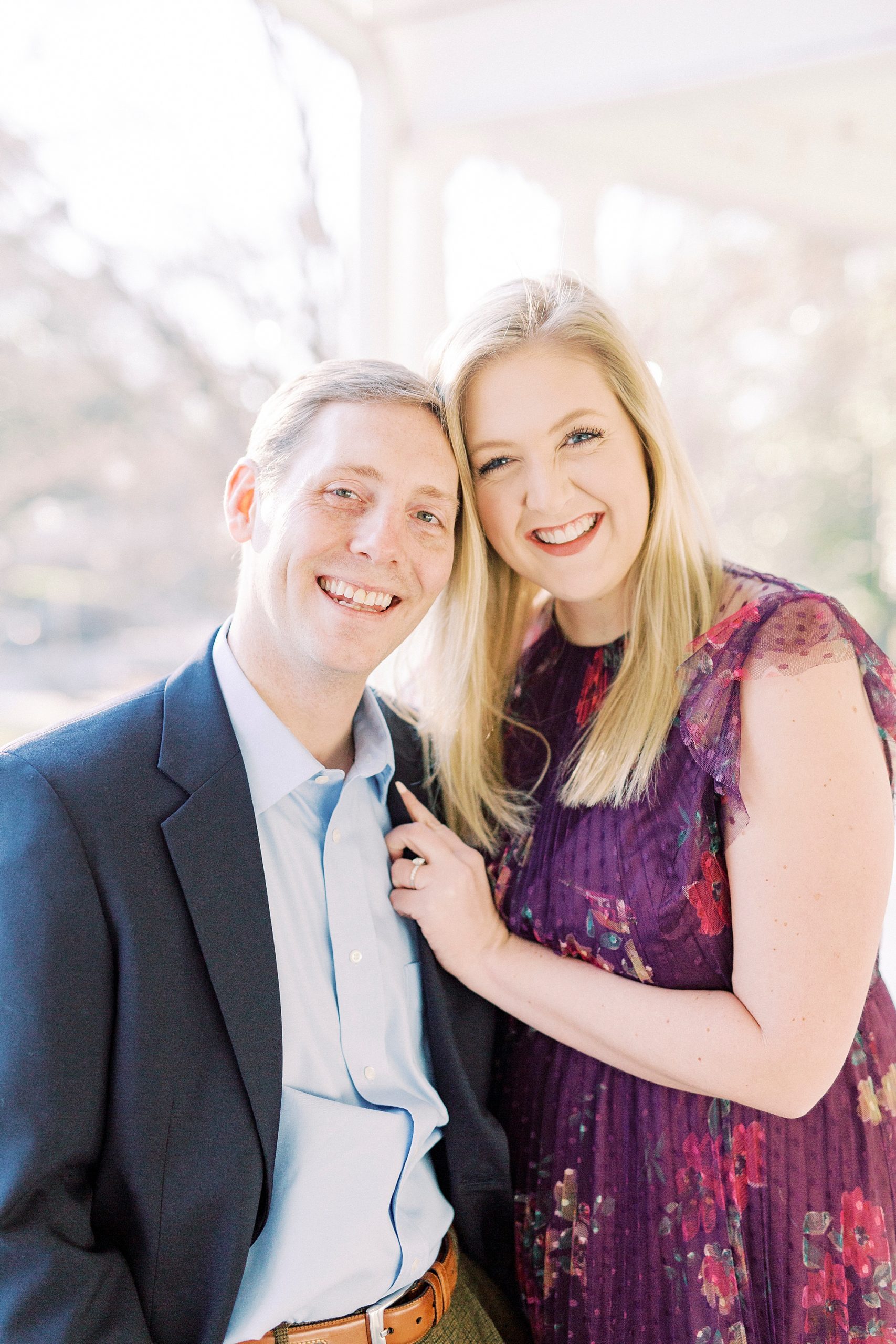 engaged couple leans heads together on patio at Ritchie Hill