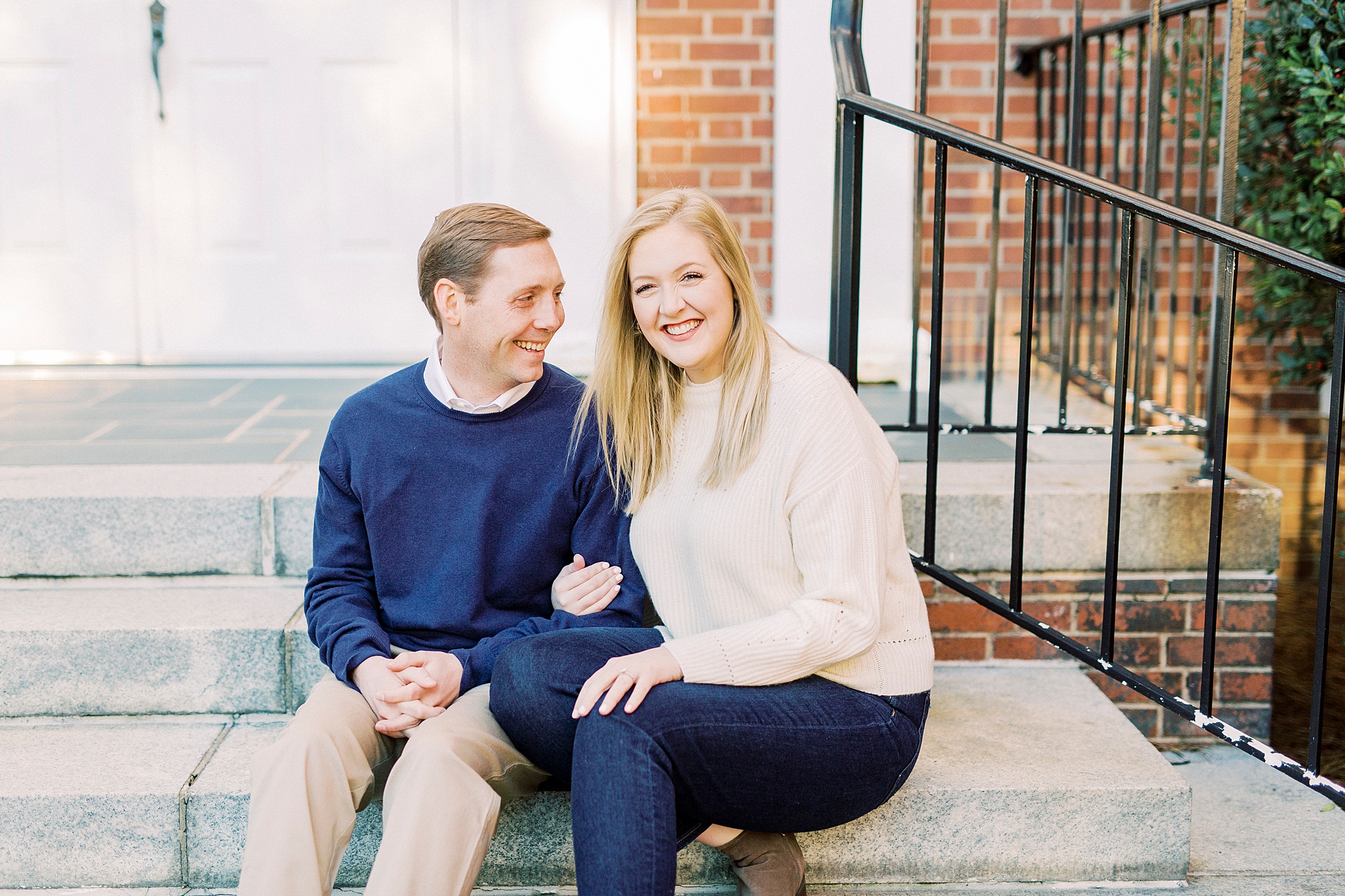 bride and groom sit on steps in Downtown Concord