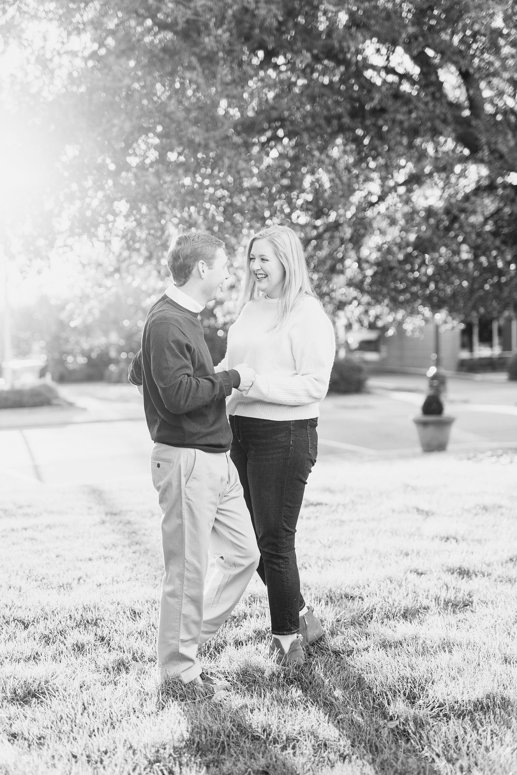 bride and groom pose under tree in park