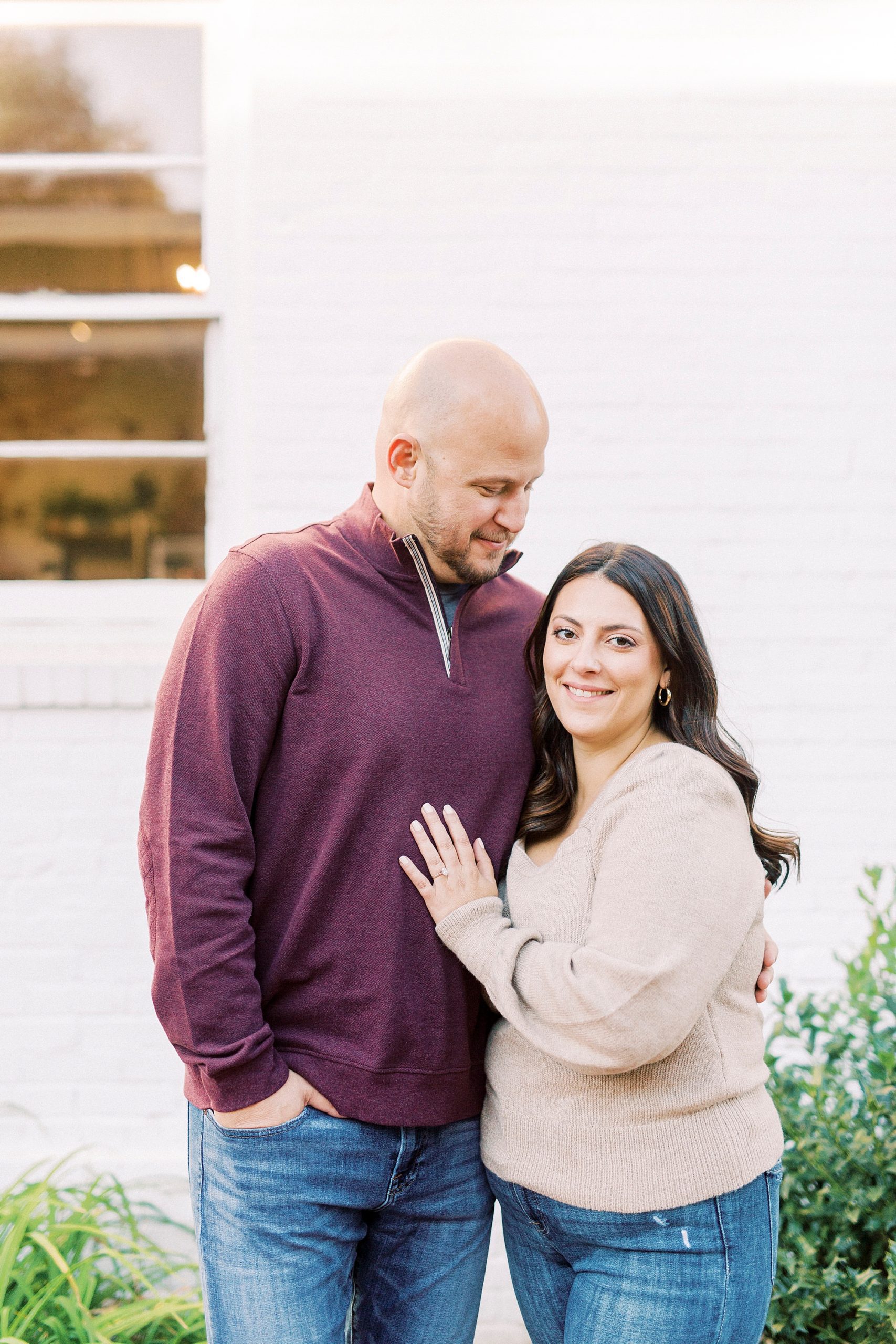 bride leans against groom during casual Downtown Matthews engagement session