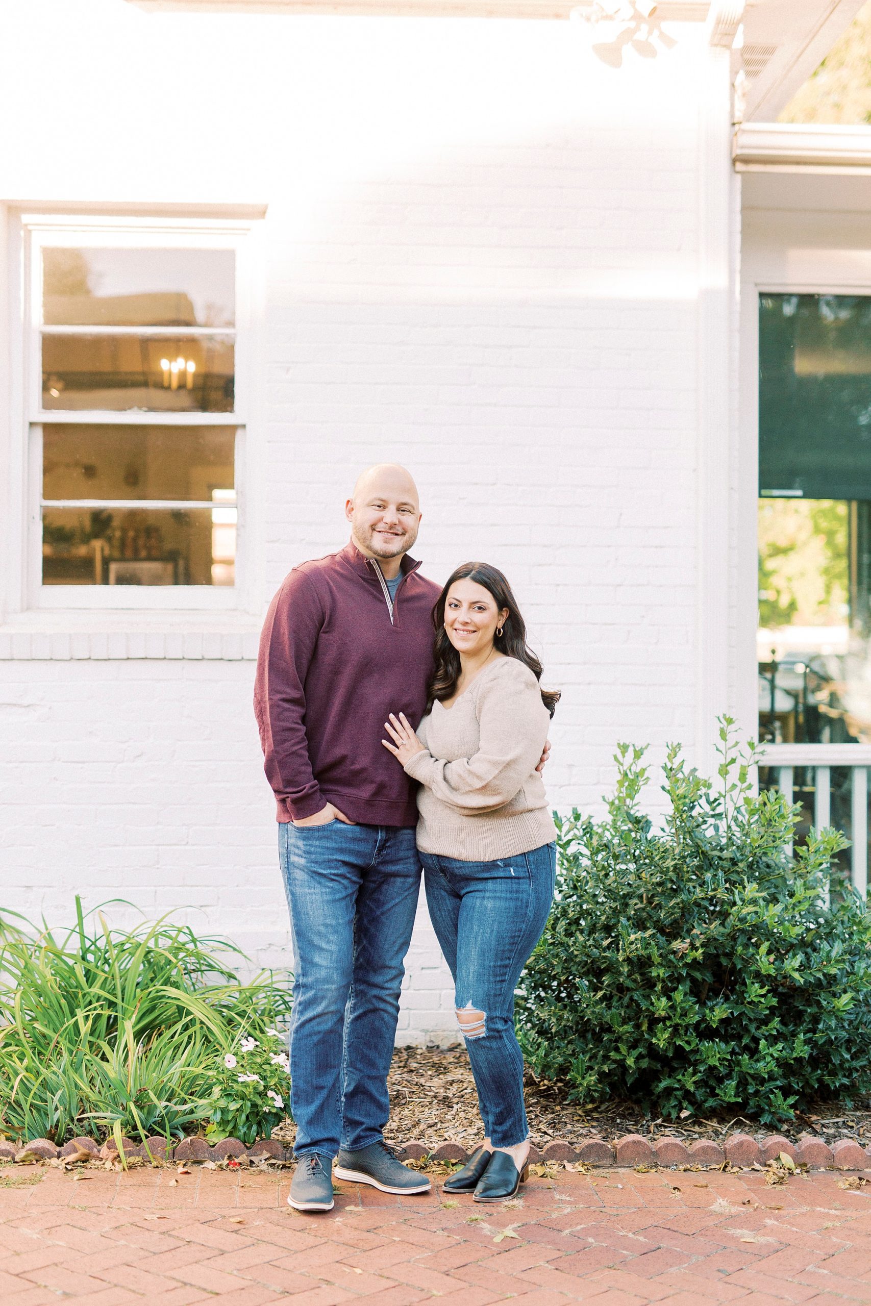 bride and groom pose outside shop in Downtown Matthews