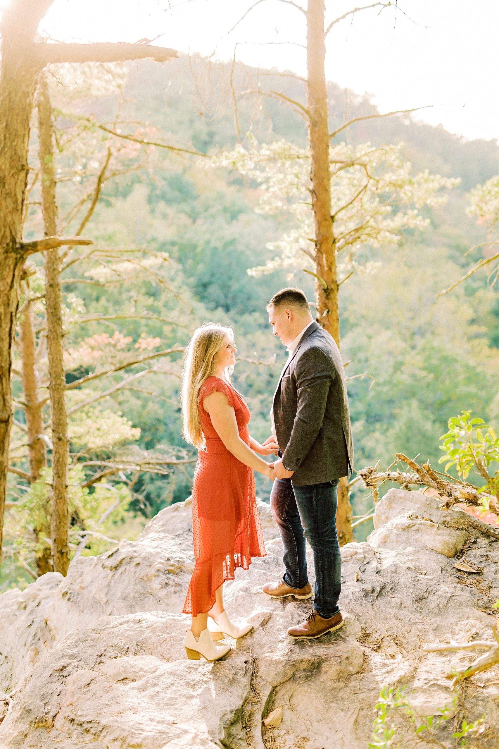 bride and groom hold hands on rocks in Hanging Rock State Park