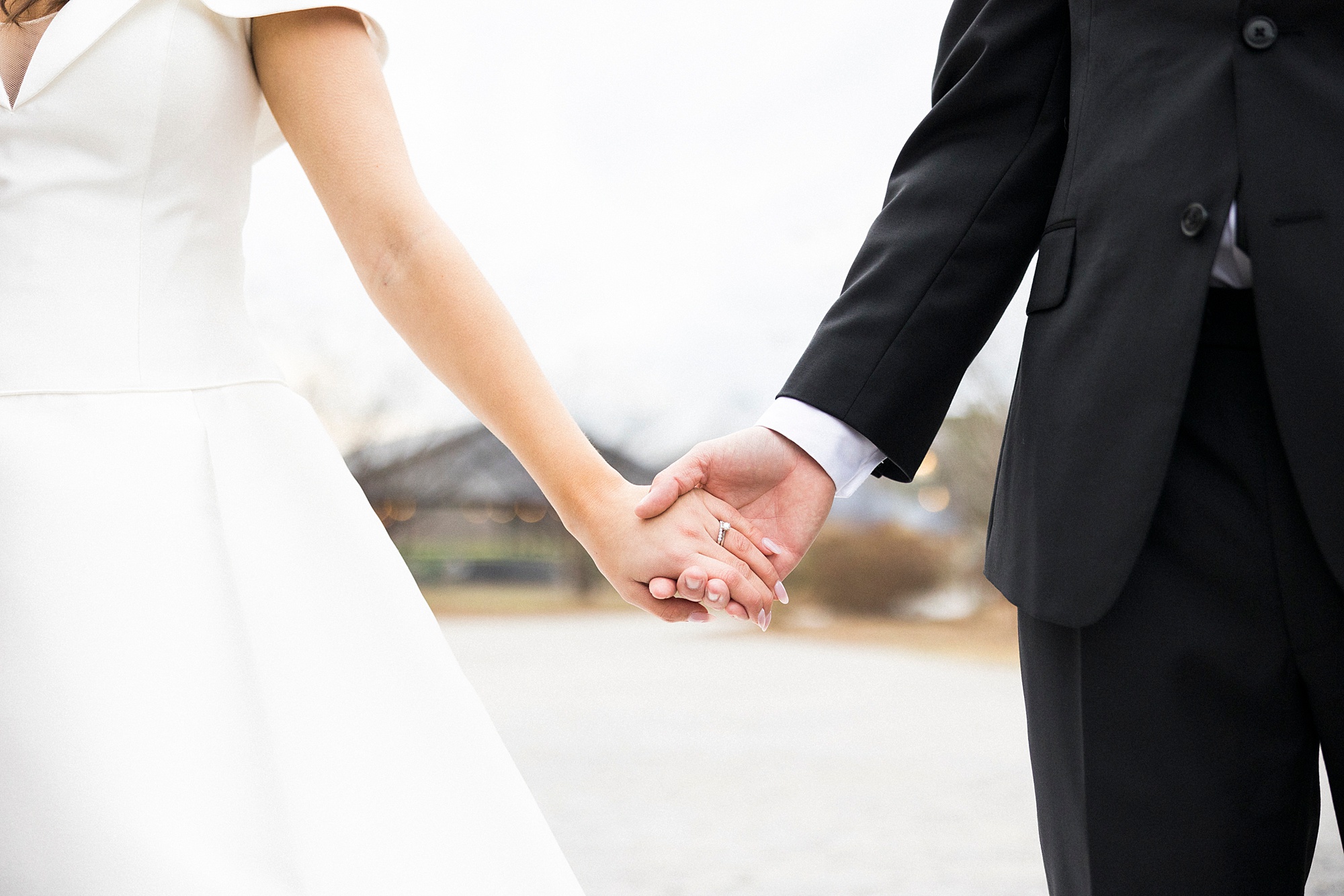 newlyweds hold hands during NC wedding portraits