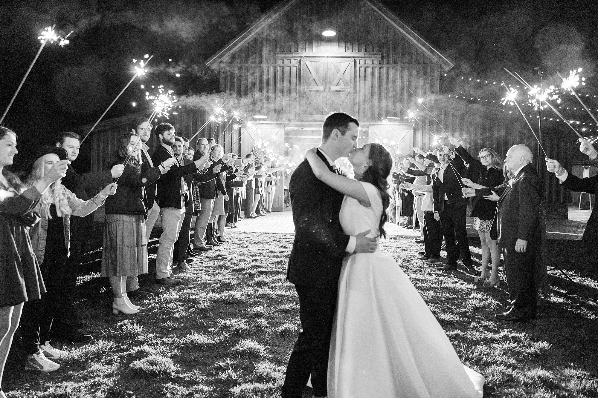 couple kisses during sparkler exit