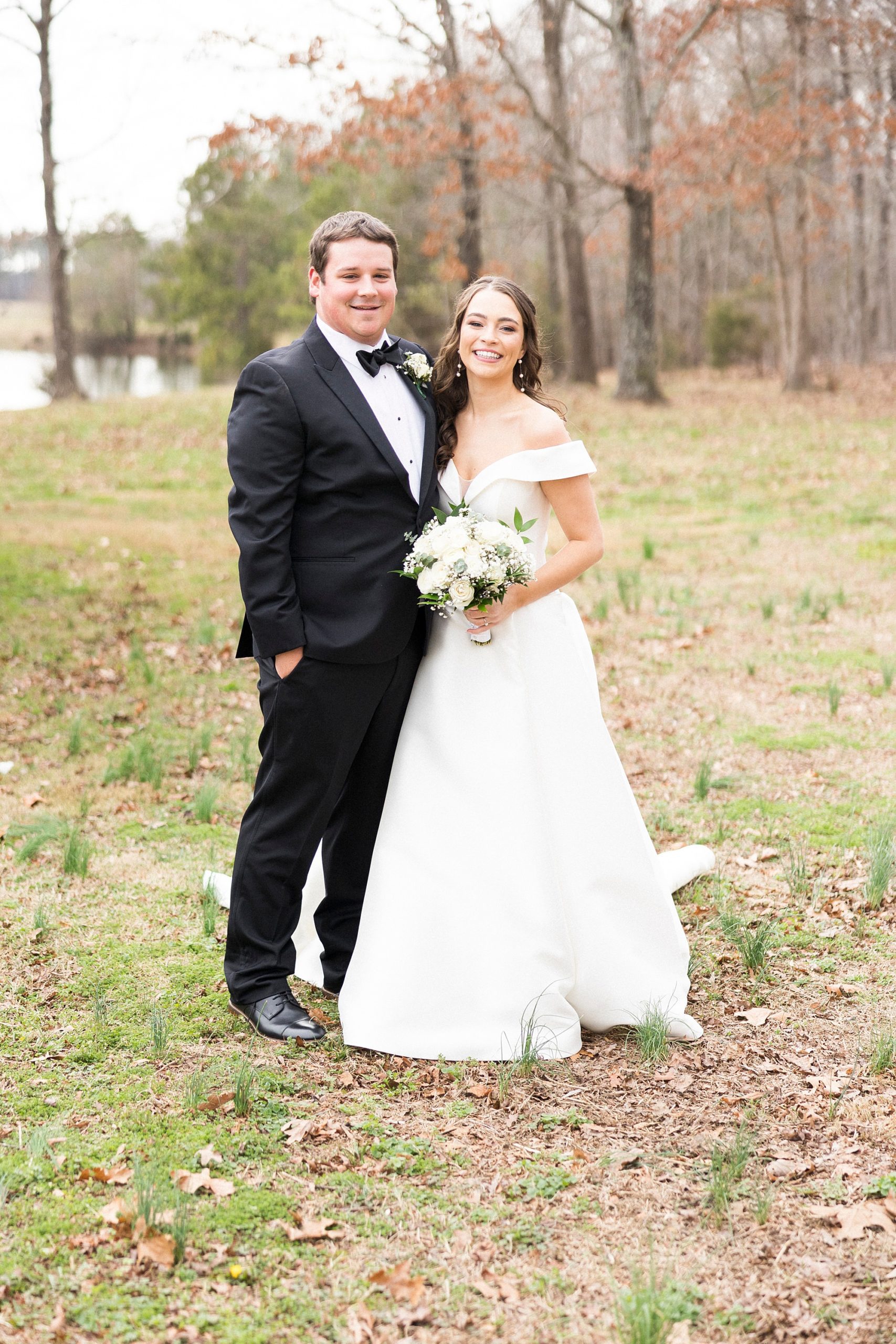 bride poses with brother after first look