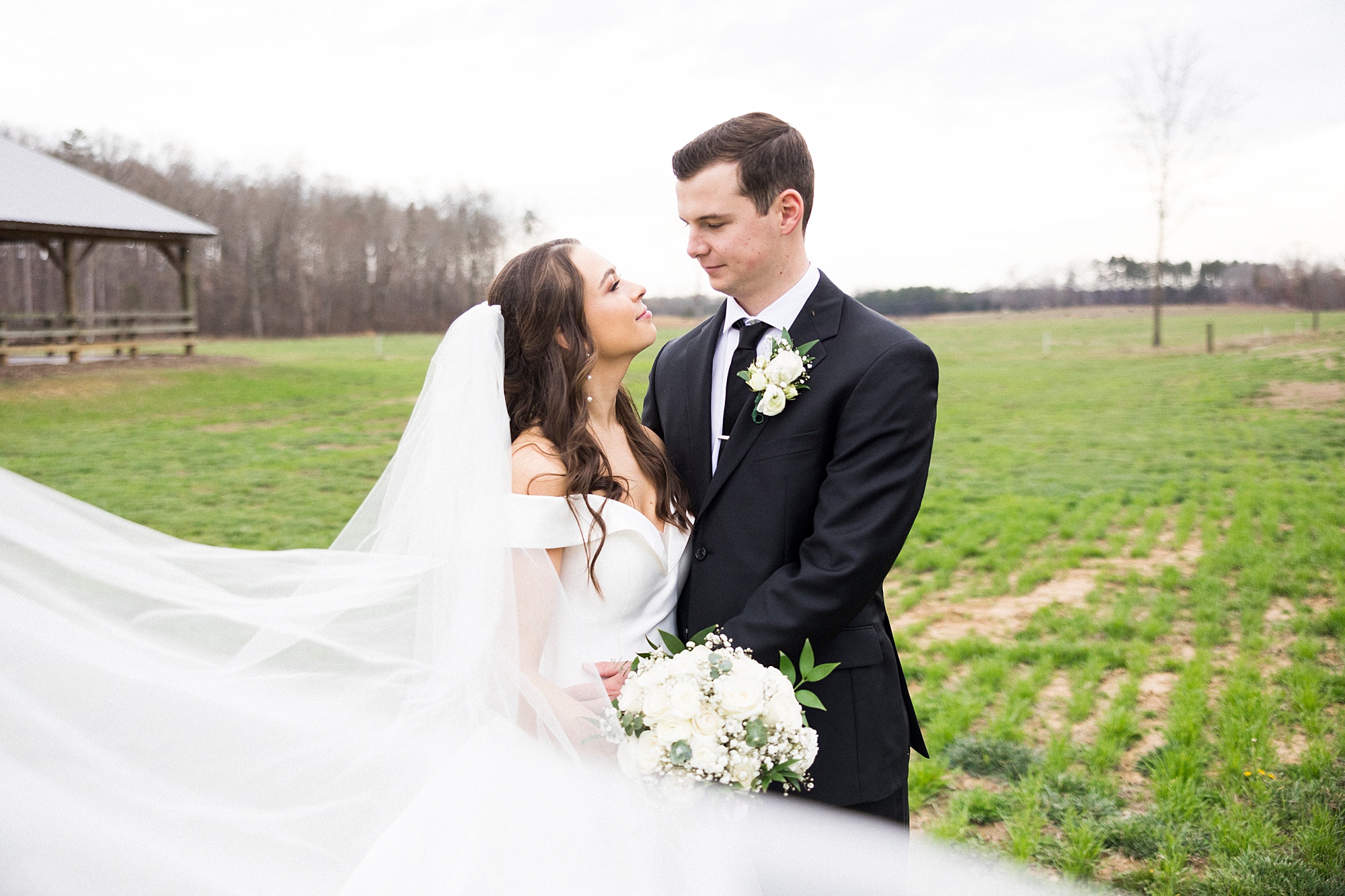 bride and groom smile together outside The Farm at Brusharbor