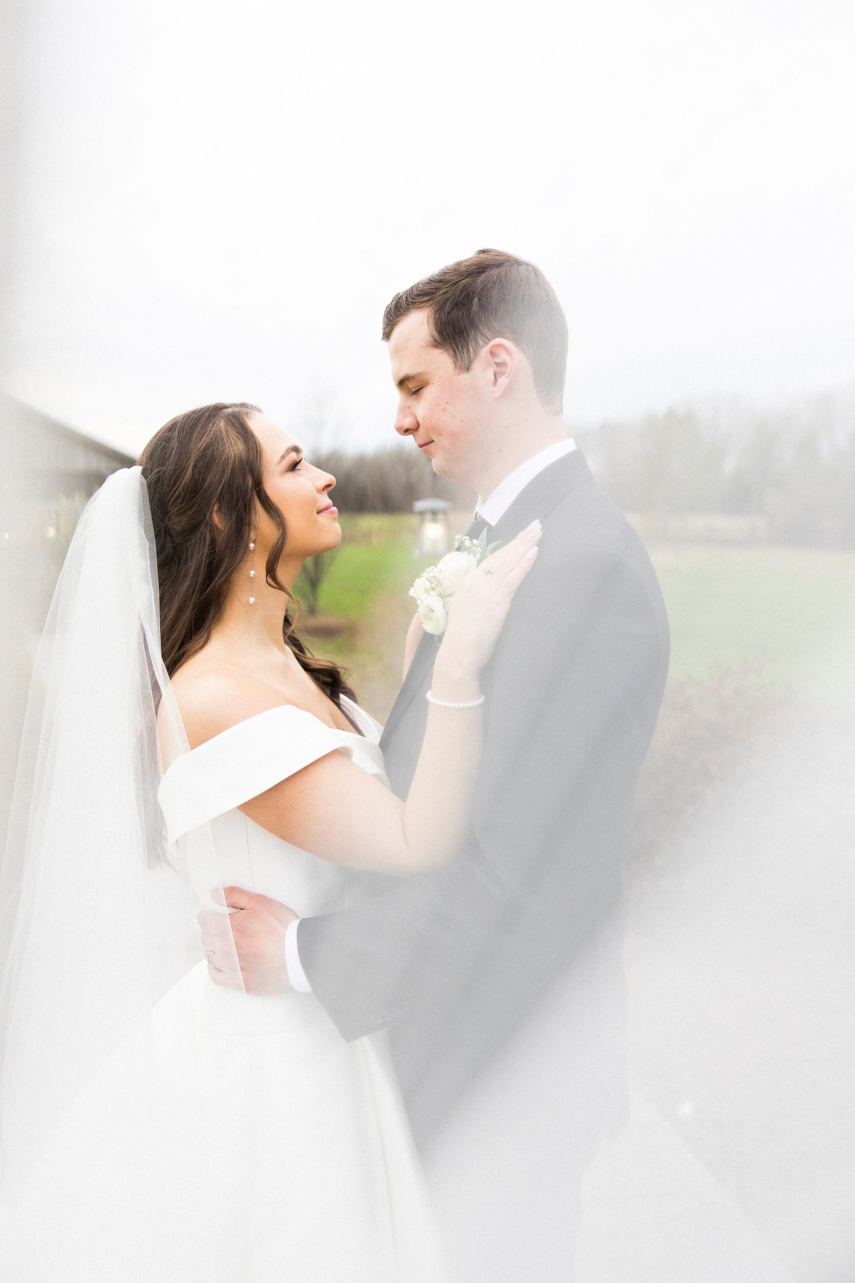bride looks up at groom during NC wedding photos