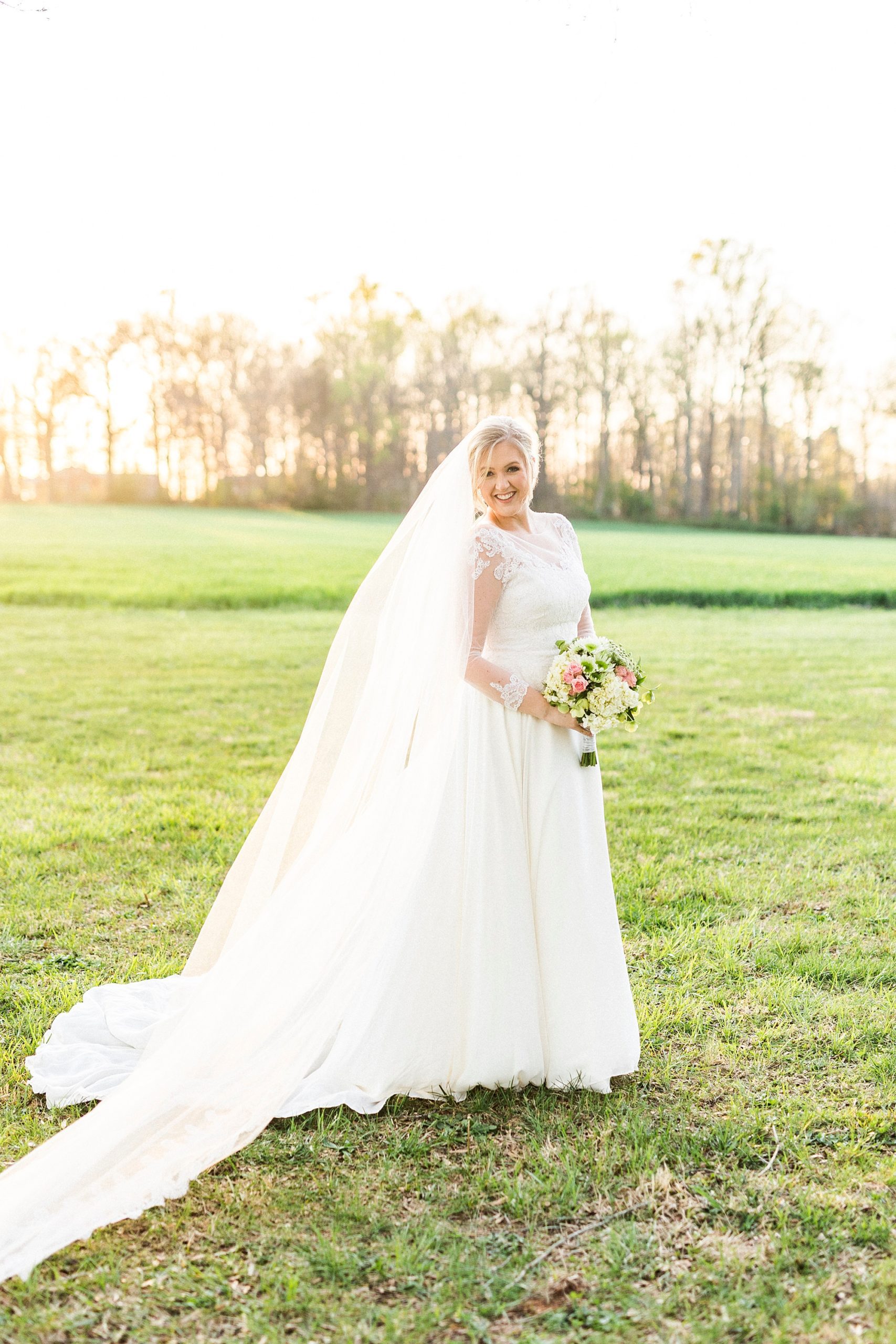 bride walks through field during Mooresville bridal portraits