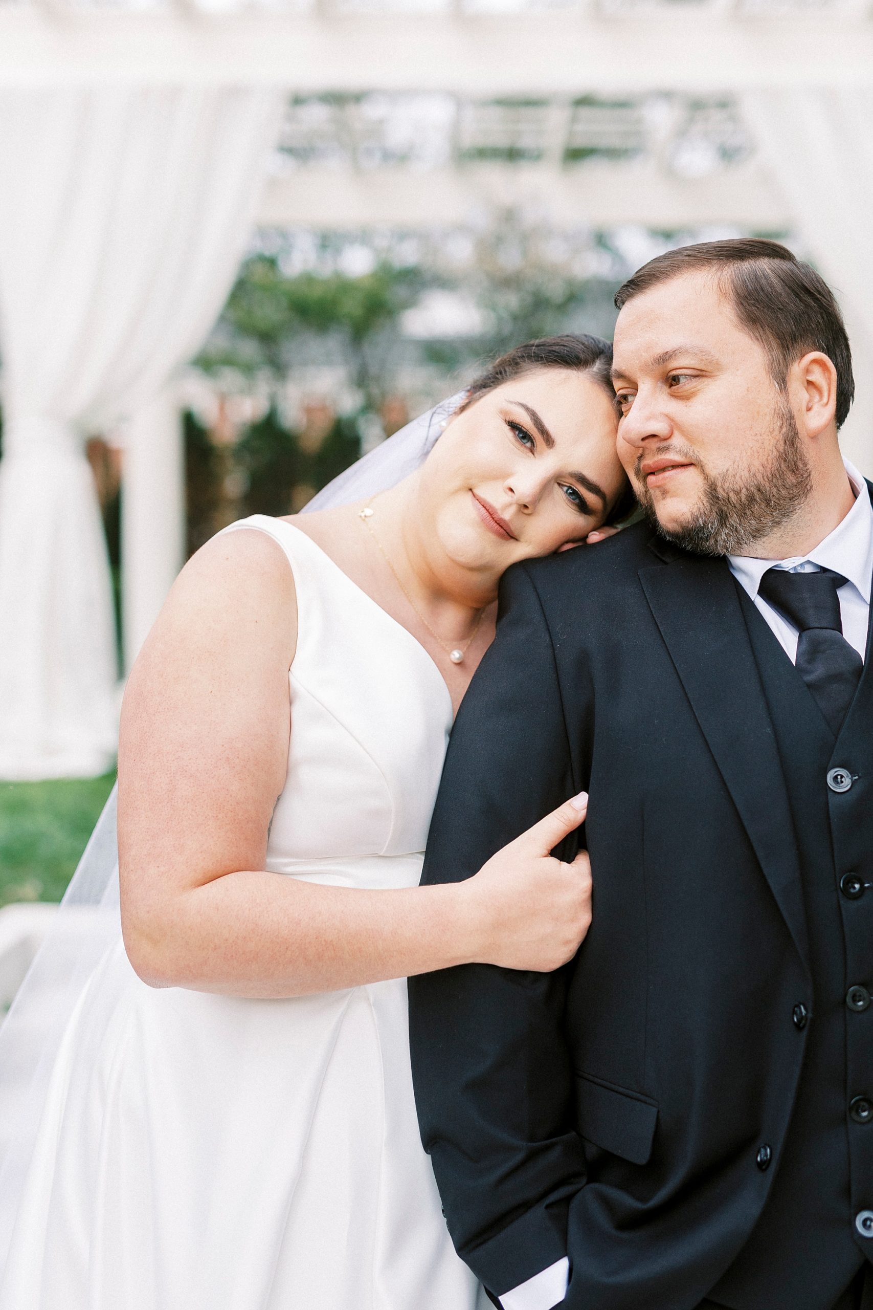 bride leans on groom's arm during portraits at the Separk Mansion