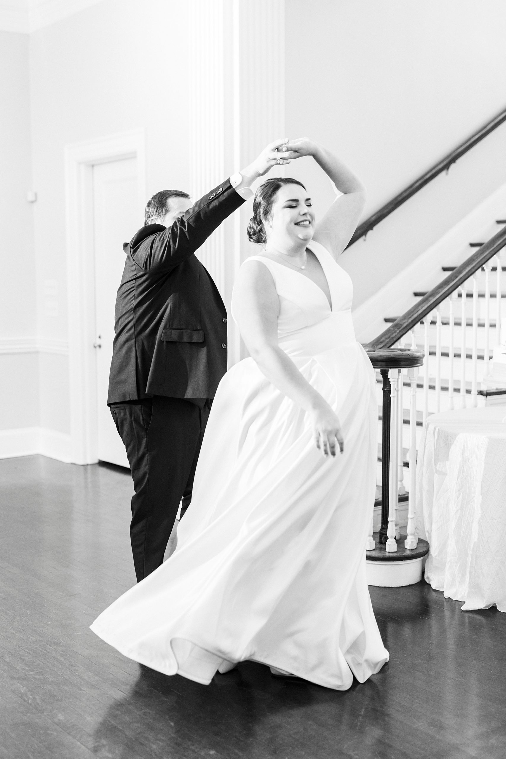groom twirls bride during Gastonia NC wedding reception
