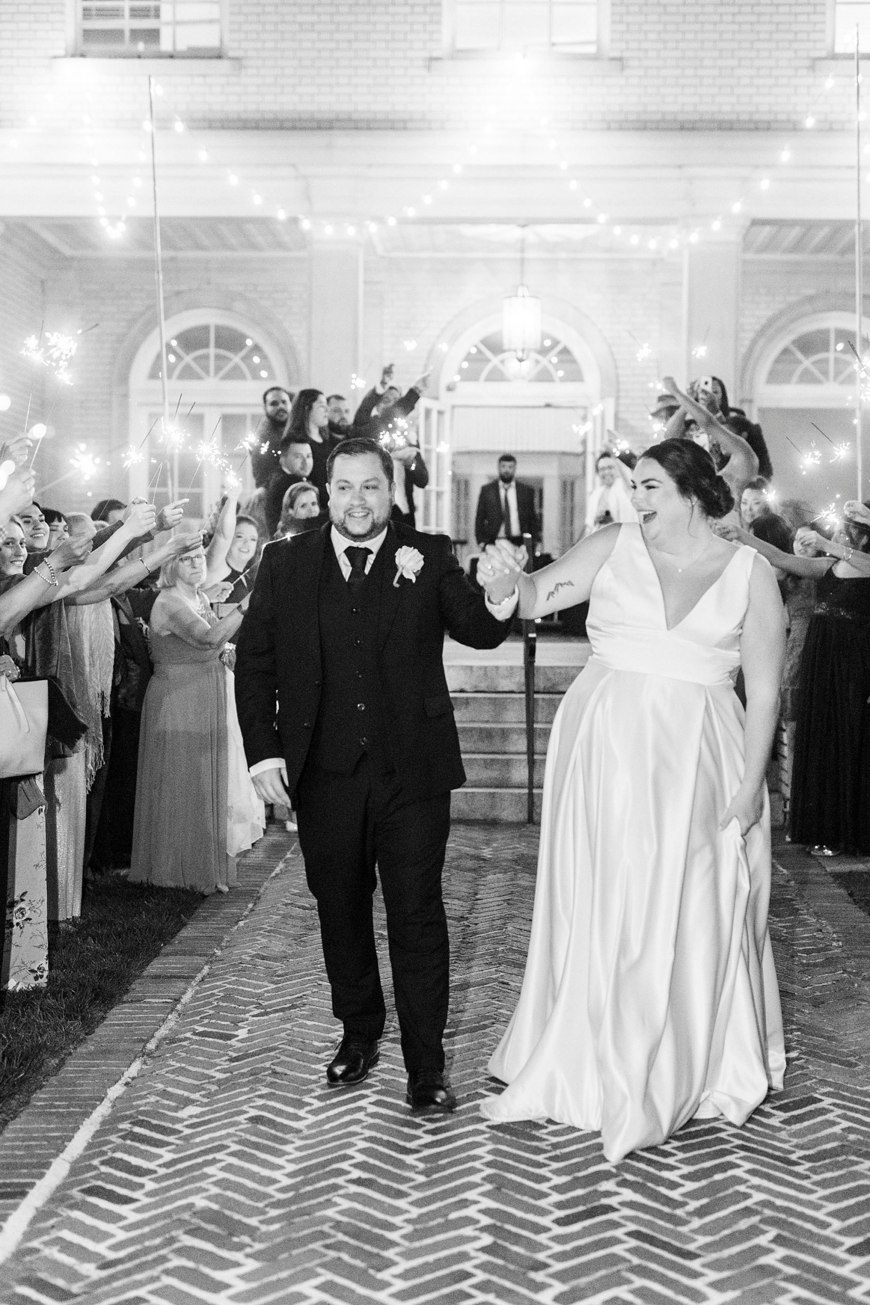 newlyweds hold hands during sparkler exit at the Separk Mansion
