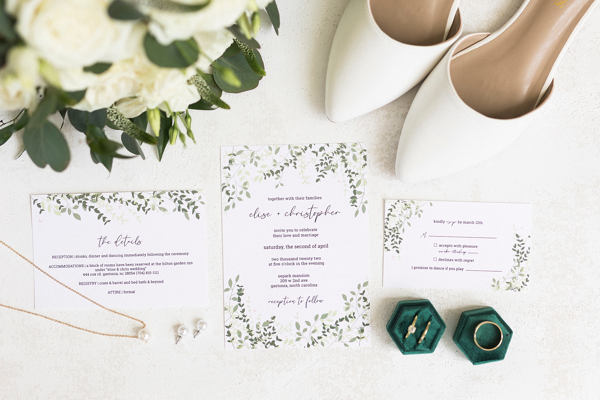 elegant wedding invitation suite with greenery details