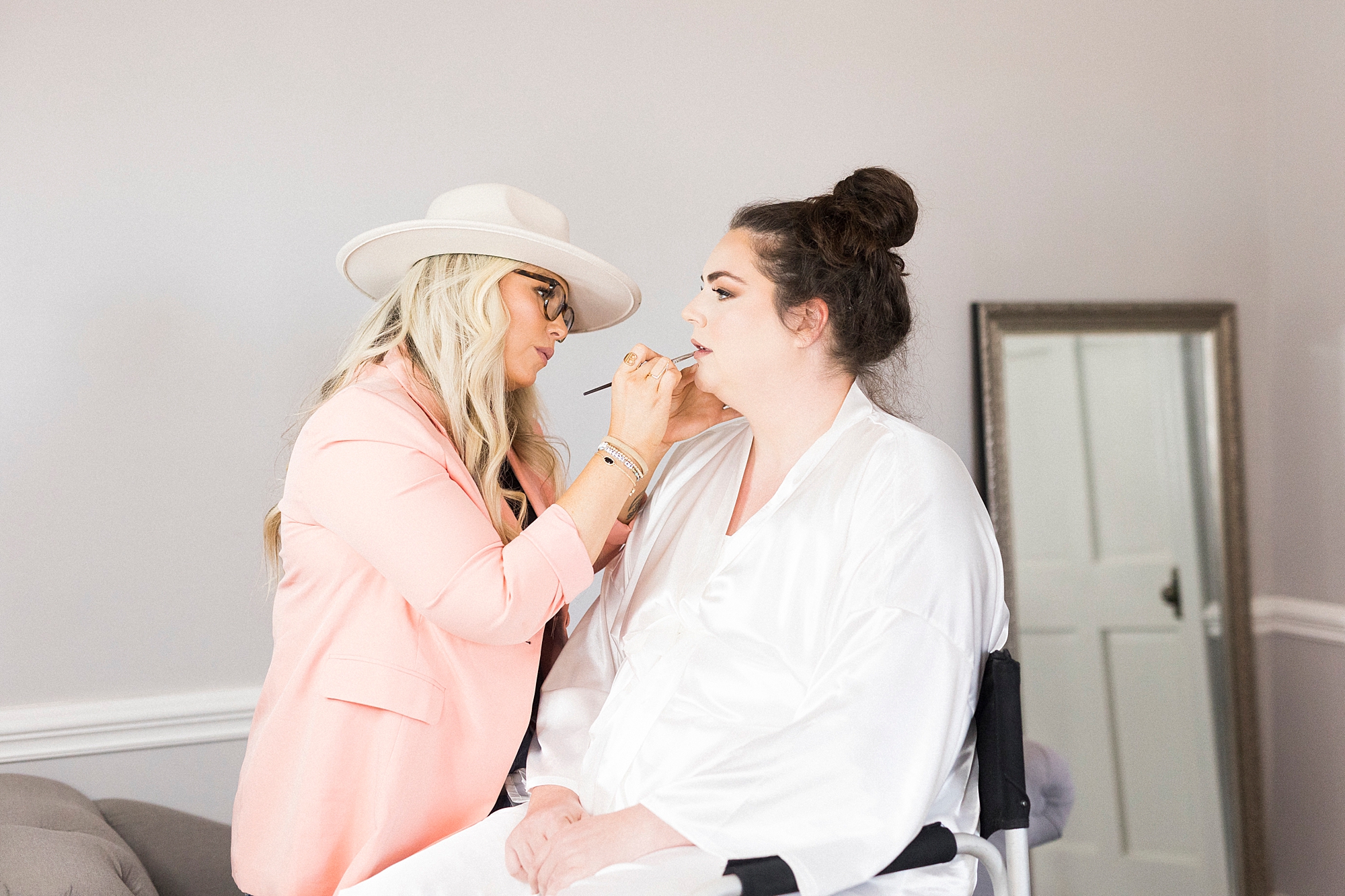 makeup artist works on bride before NC wedding day