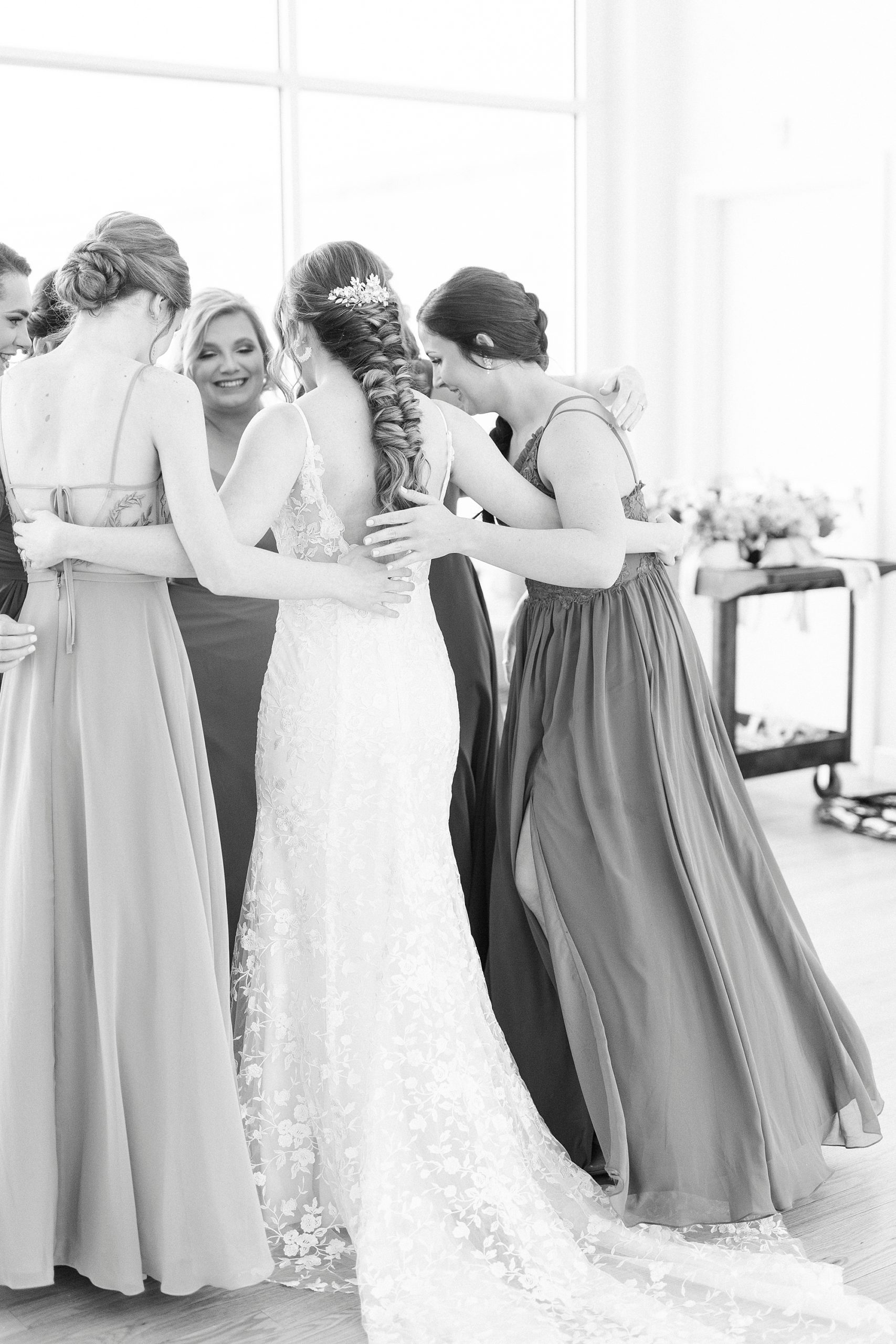 bride hugs bridesmaids during prep at Stockroom at 230