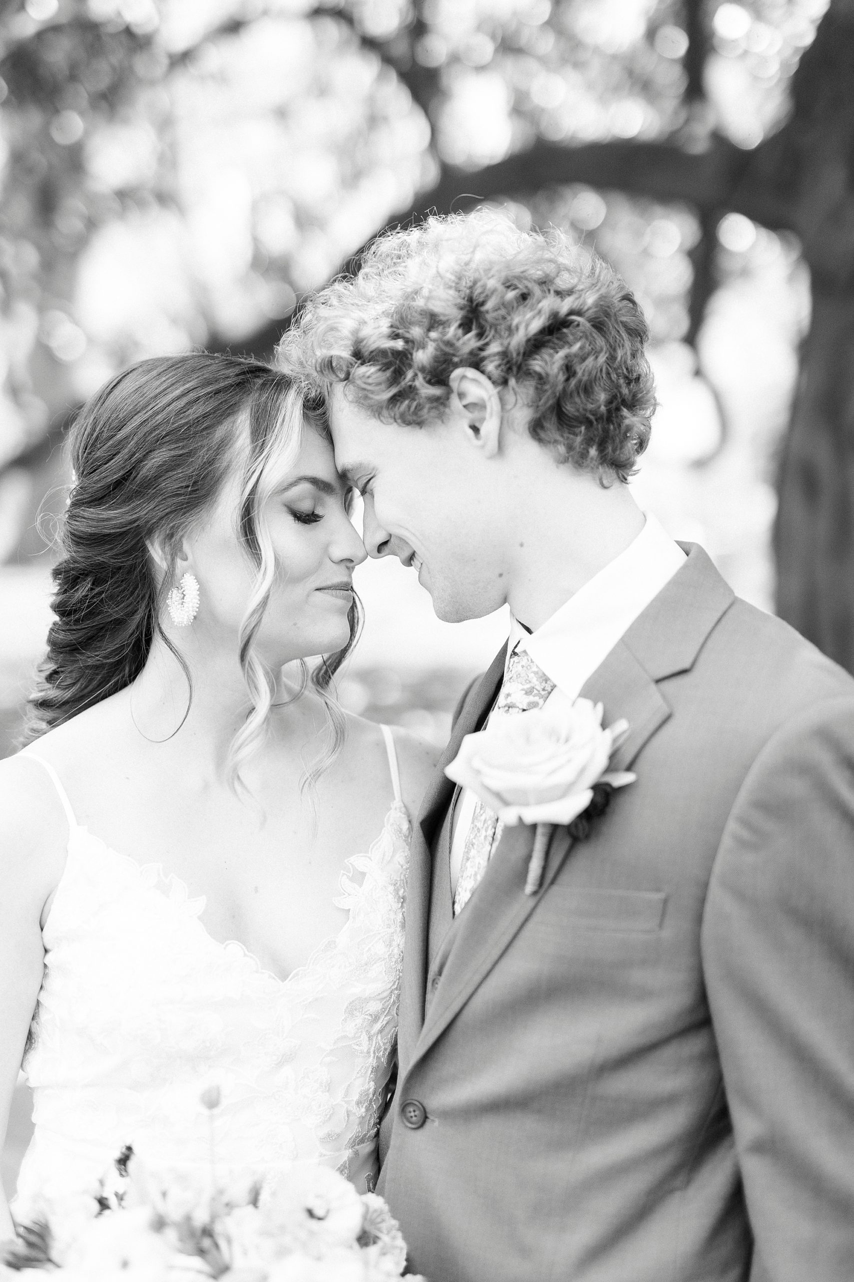 bride and groom lean foreheads together during portraits outside the Stockroom at 230