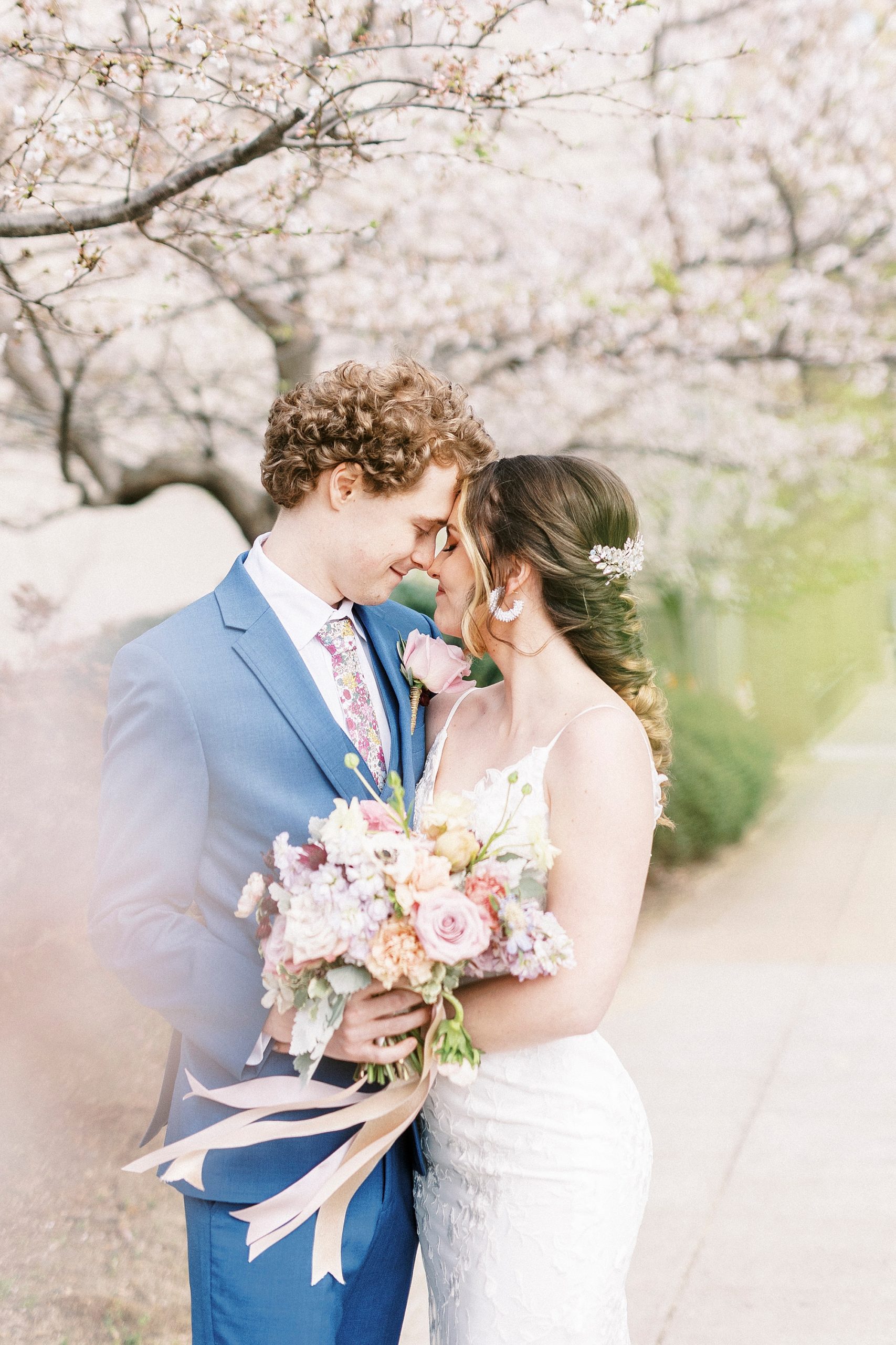 bride and groom smile together with noses touching in NC