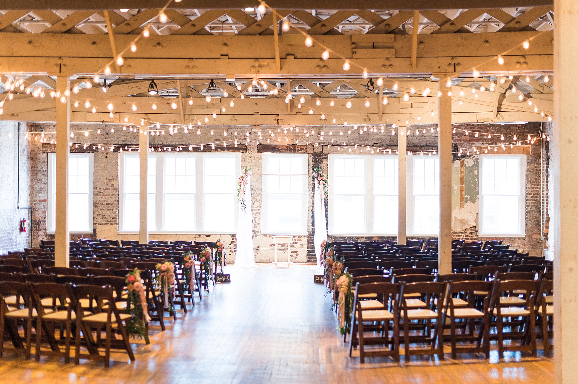 ceremony site with hanging patio lights at Stockroom at 230
