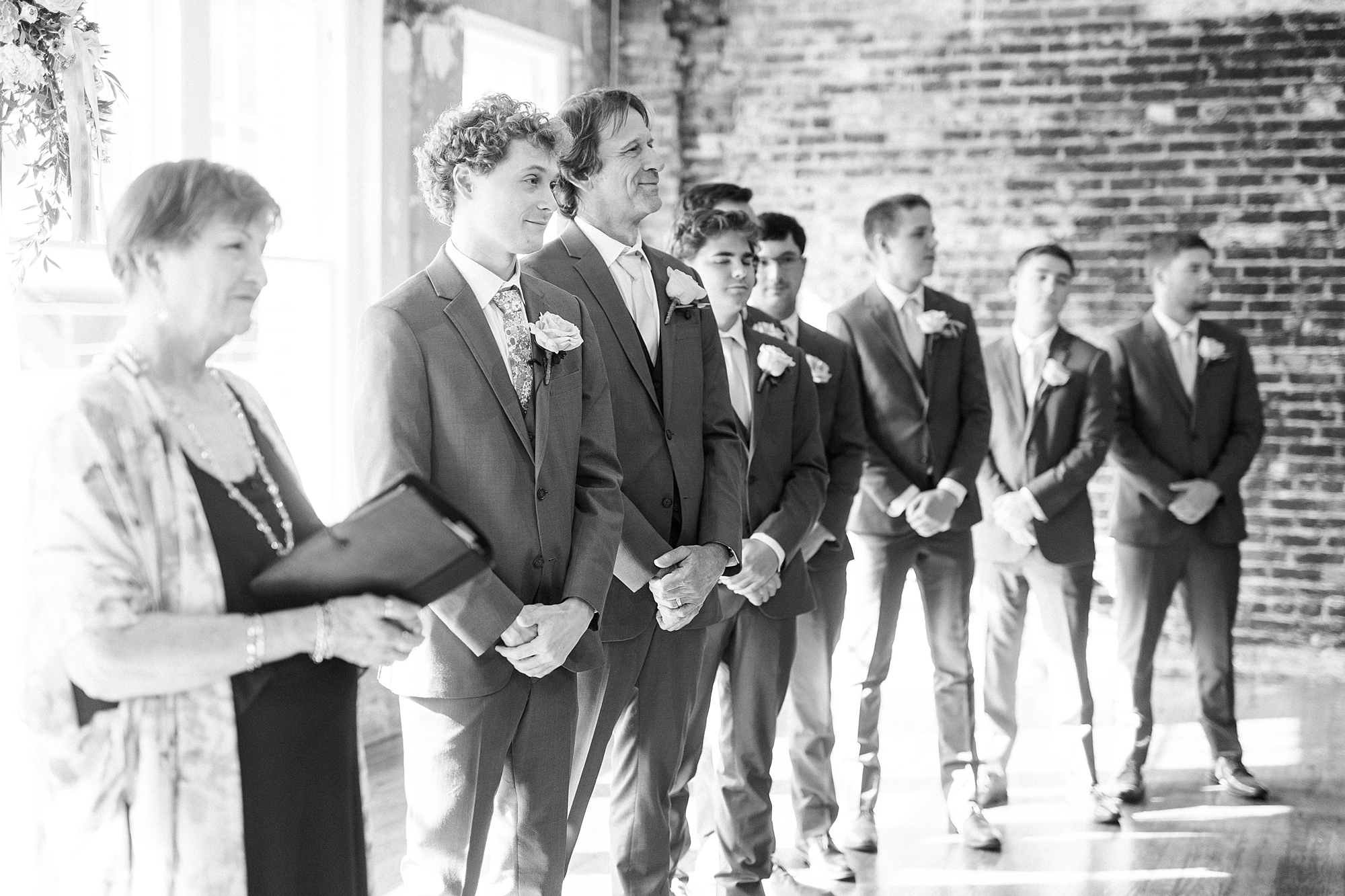 groom watches bride walk down aisle
