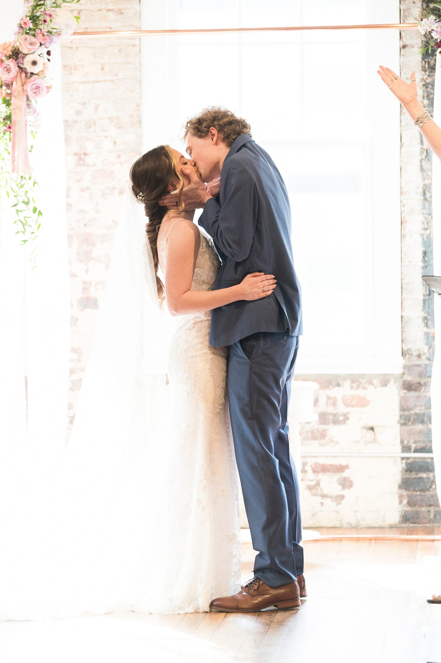 newlyweds kiss during ceremony in Raleigh NC